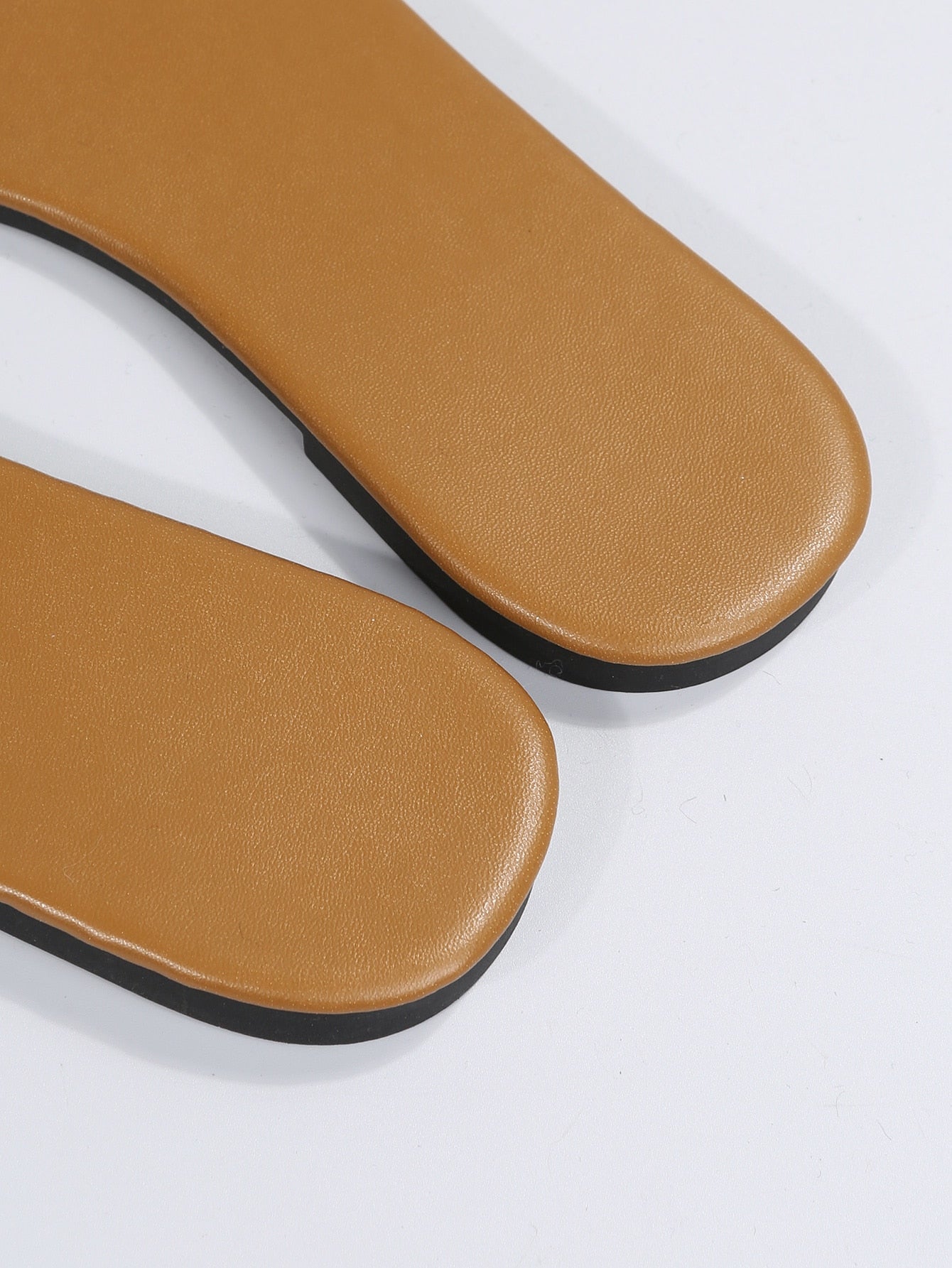 Women’s clear flat slide sandals with a single transparent band and open toe design.