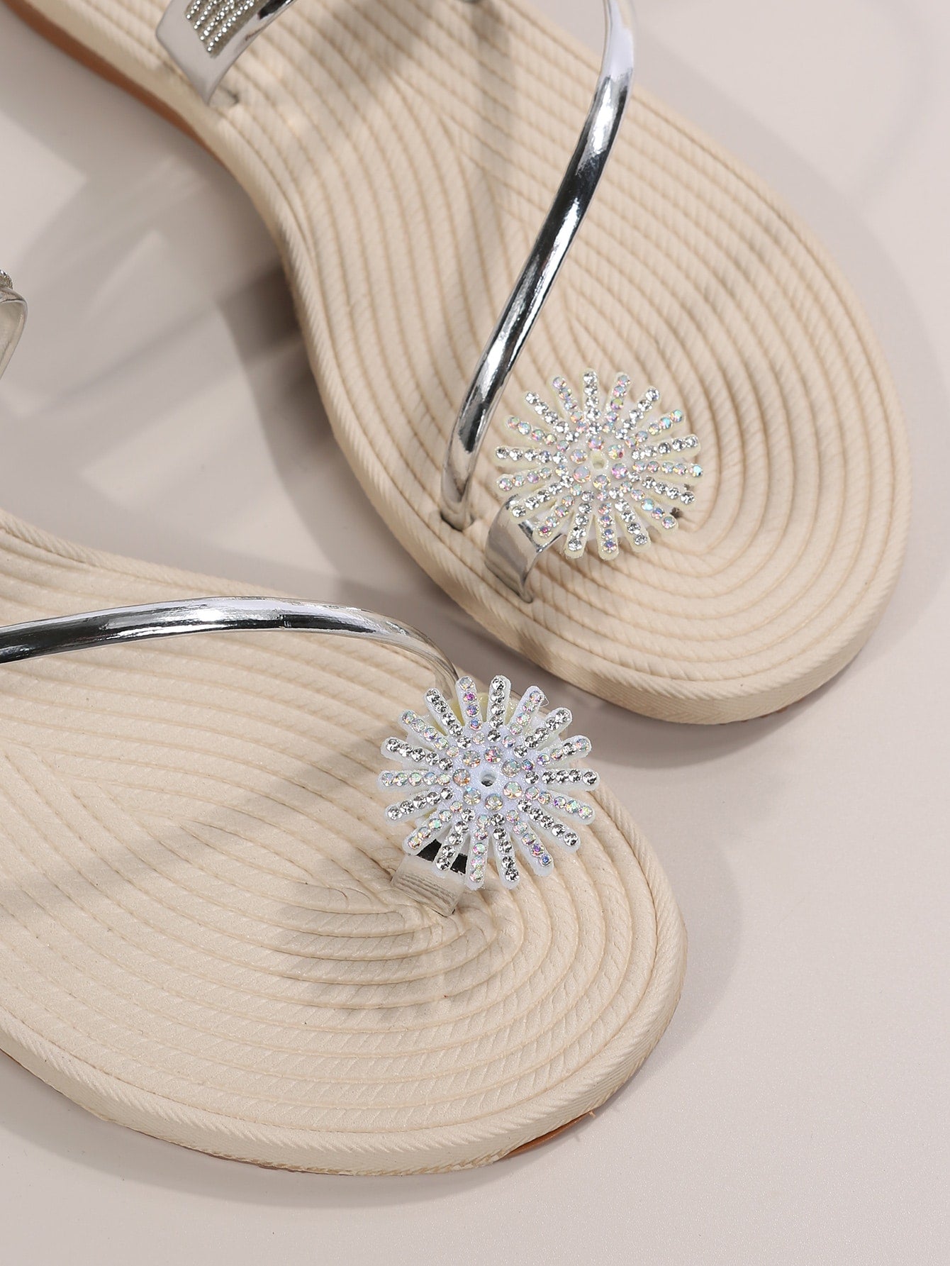 Women's casual flat sandals with slip-on criss-cross straps, toe post design, and rhinestone detail, suitable for beach and summer vacation wear.