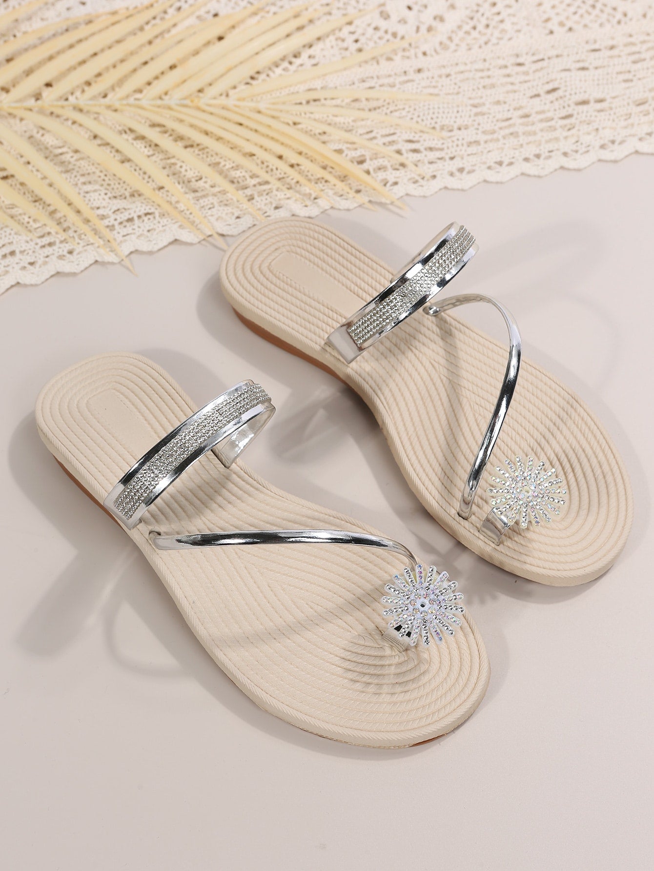 Women's casual flat sandals with slip-on criss-cross straps, toe post design, and rhinestone detail, suitable for beach and summer vacation wear.