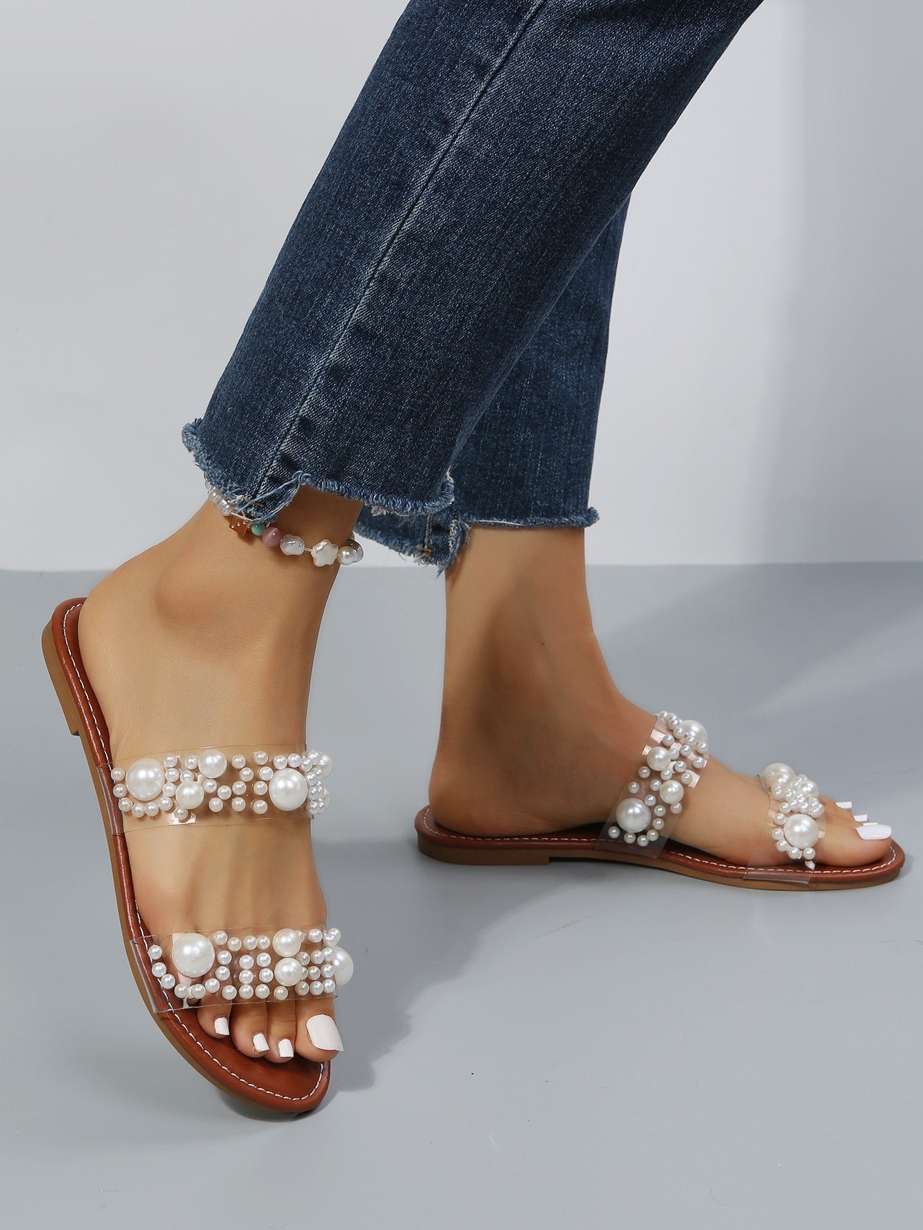Women's brown pearl decor thong flat sandals in slip-on slide style with open toe.
