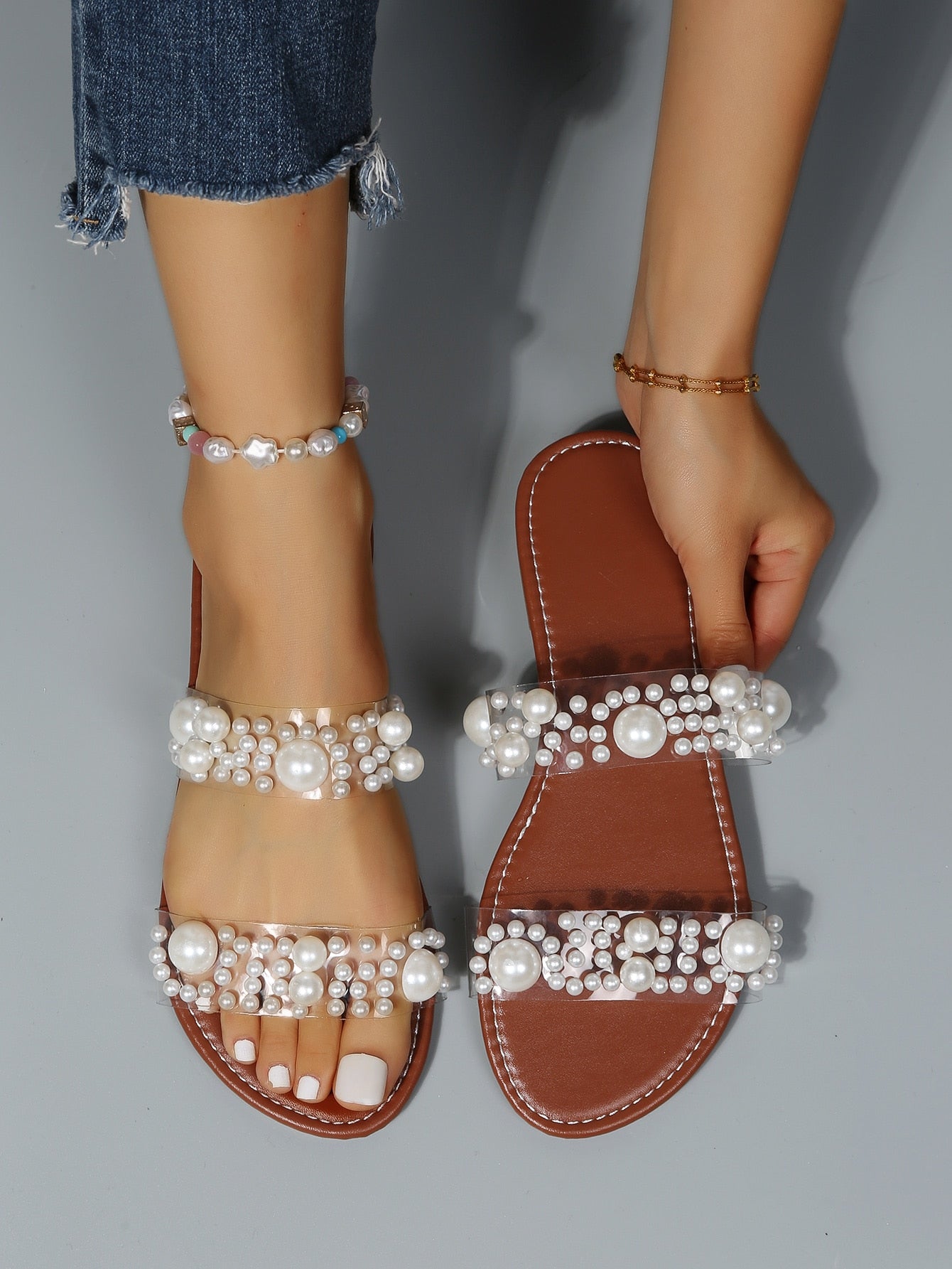 Women's brown flat thong slide sandals with pearl decor, open toe, and slip-on design for casual outdoor and beach vacation wear.