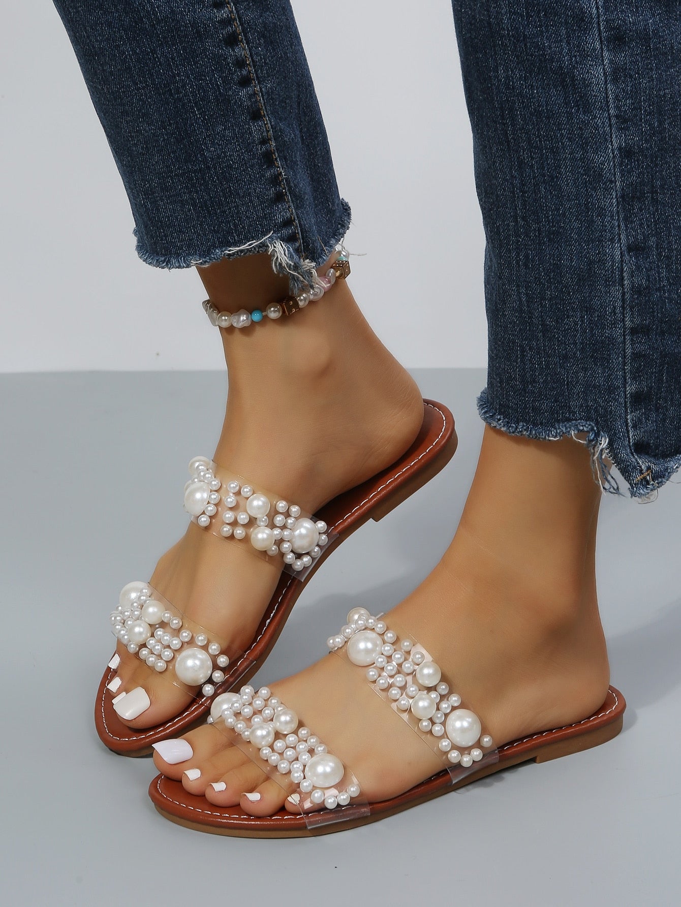 Women's brown pearl decor thong flat sandals in slip-on slide style with open toe.