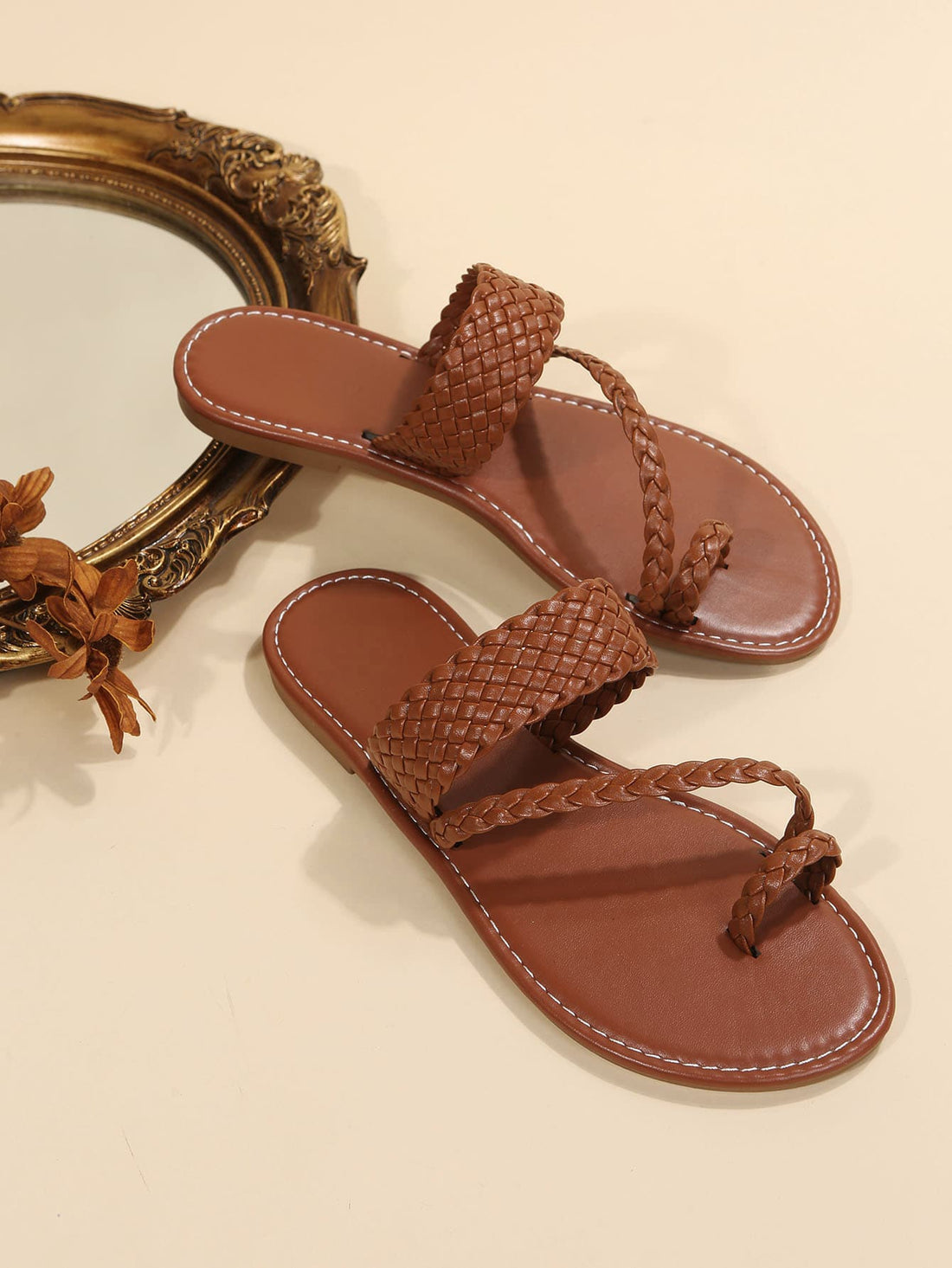 Women's brown flat thong sandals with braided straps, buckle detail, and toe post design for casual outdoor spring and summer wear.