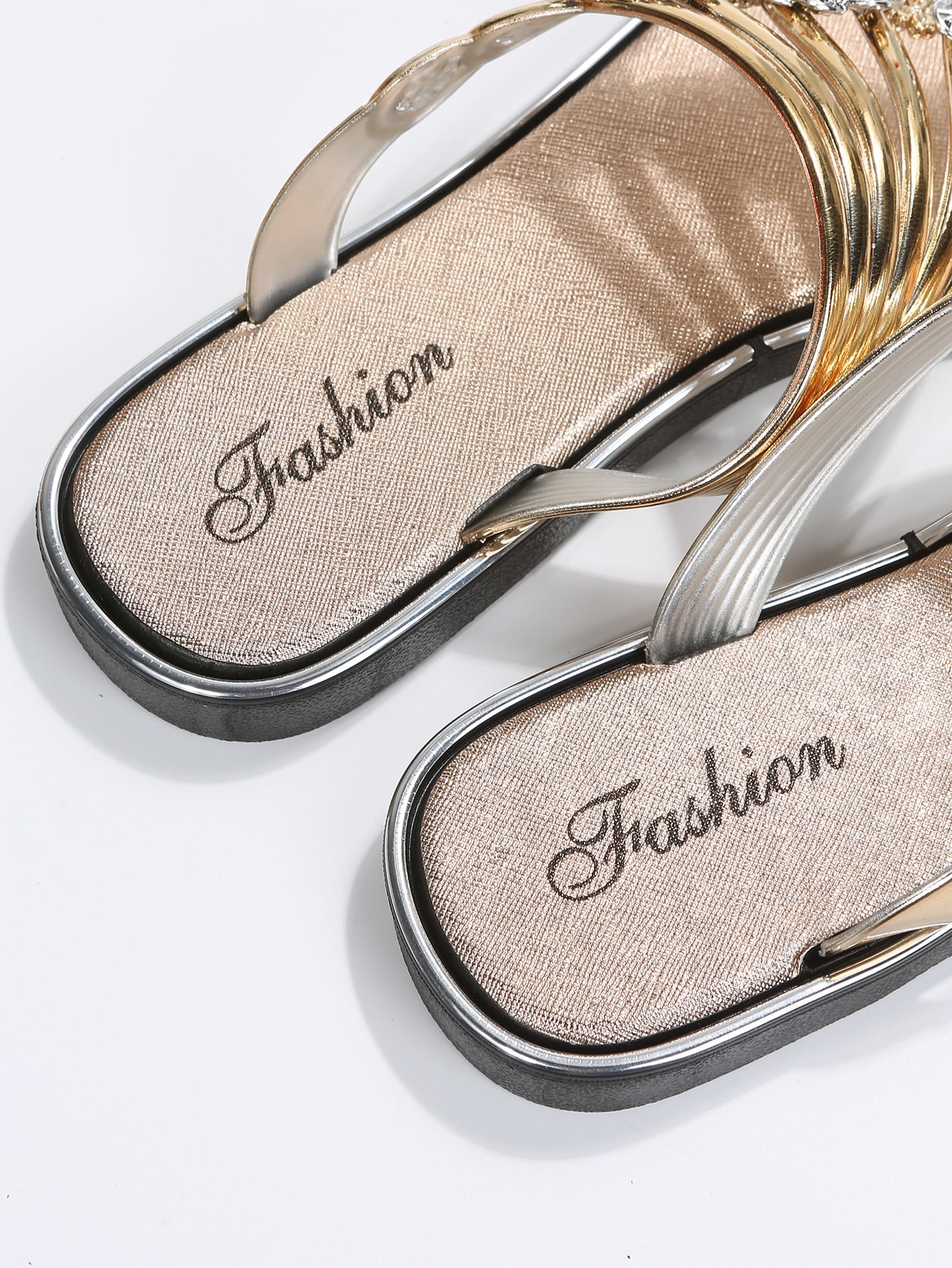 Women’s gold metallic flat thong sandals with rhinestone and flower decor, toe post design, and beach-ready style.