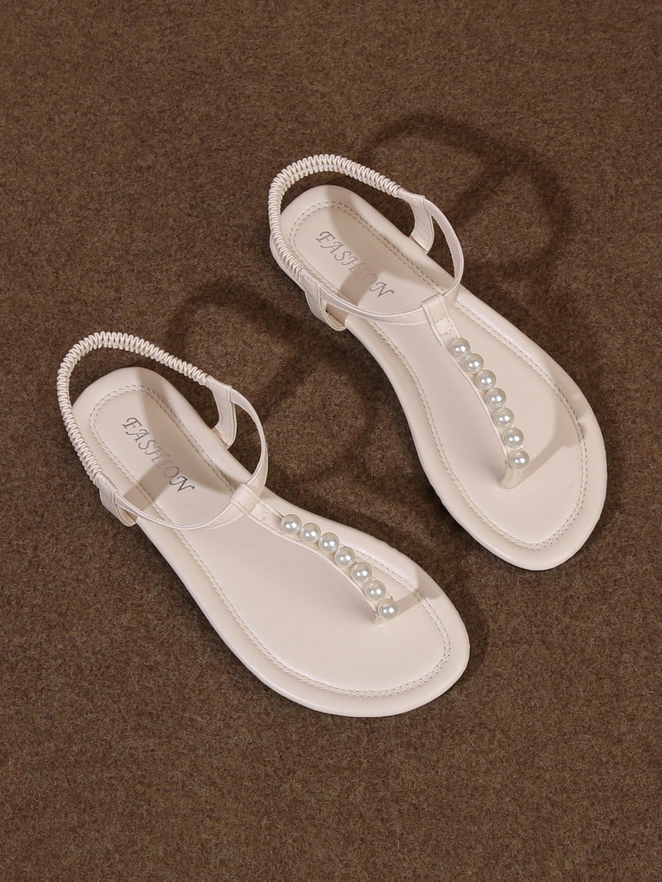 Women’s Roman style strap slide sandals with flat sole, buckle detail, and round toe, designed as casual slip-on beach and outdoor sandals.