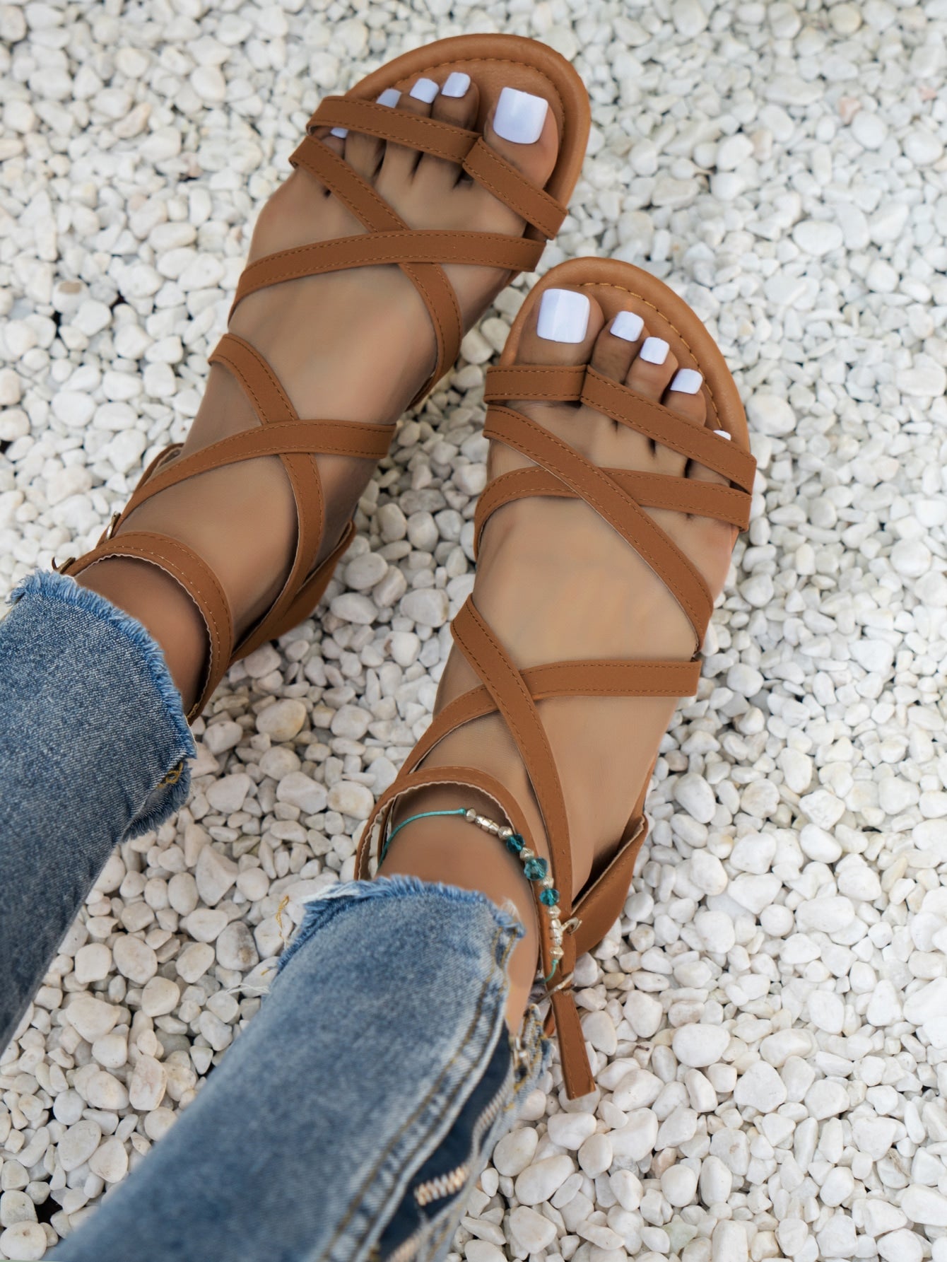 Women’s flat boho gladiator sandals with cross straps, open toe, buckle detail, and back zipper, styled for beach and casual summer wear.