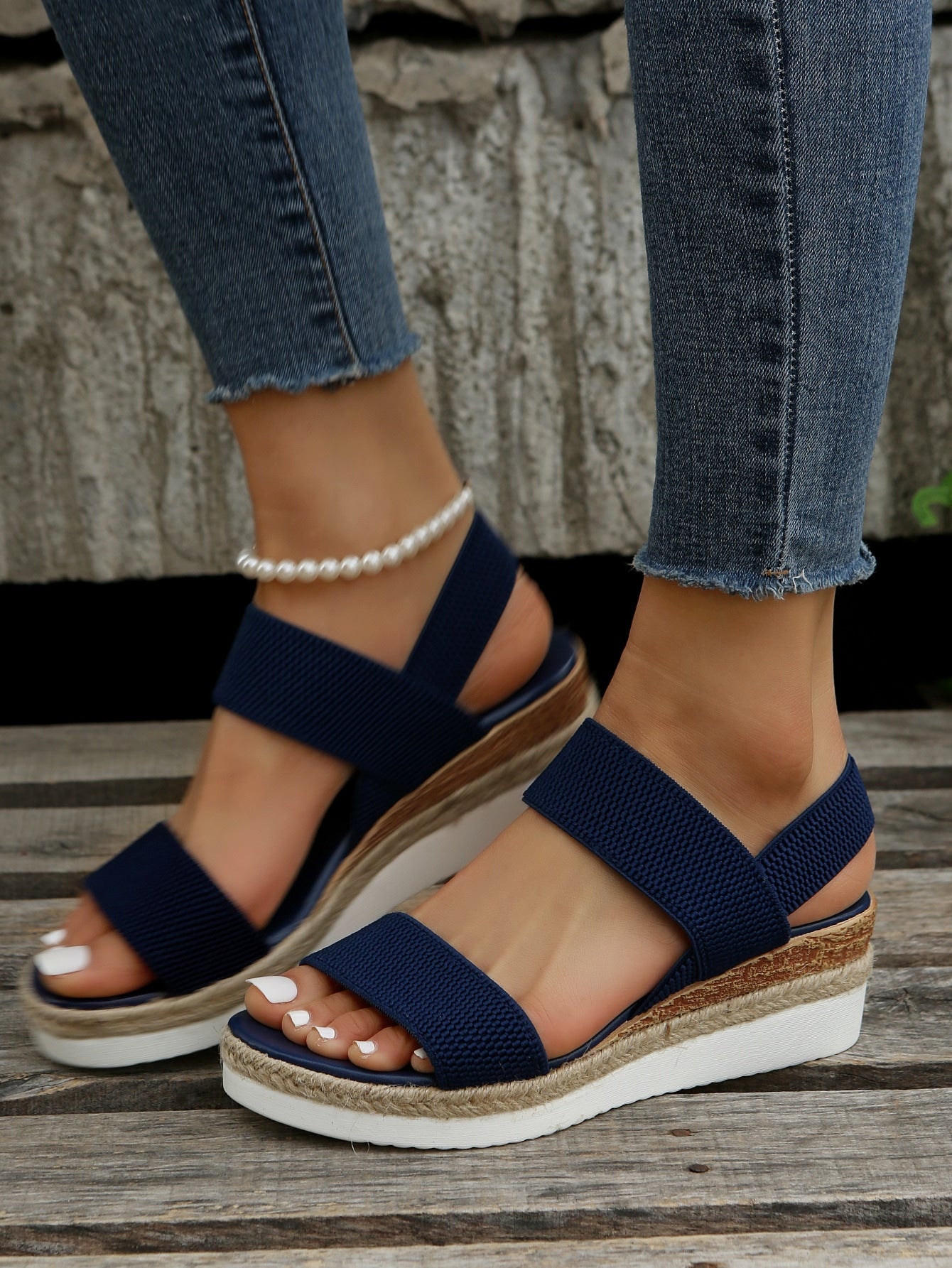 Women's slip-on crisscross wedge sandals with open toe, slingback strap, buckle detail, and mid wedge heel in a casual style.