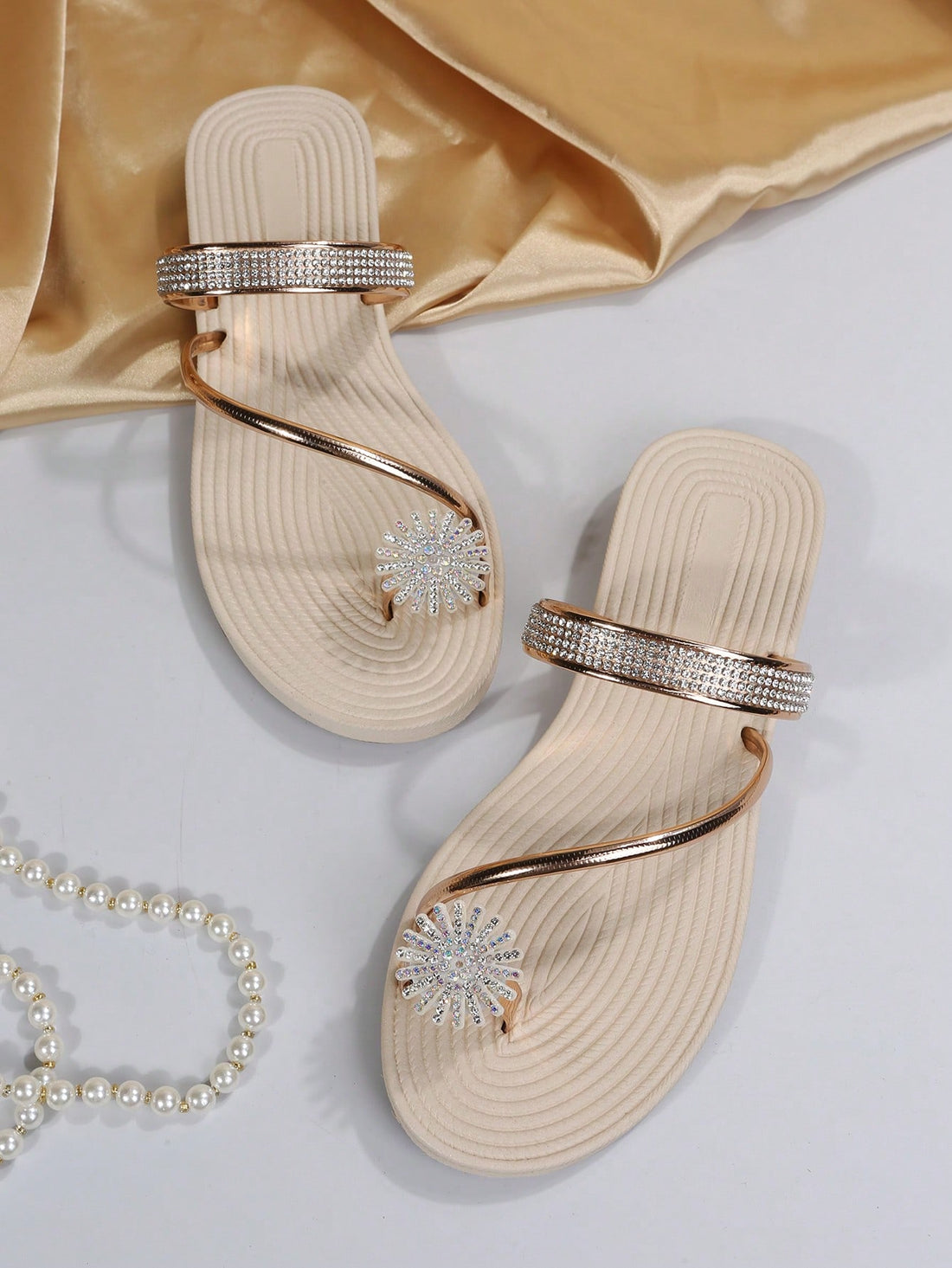 Women's casual flat sandals with slip-on criss-cross straps, toe post design, and rhinestone detail, suitable for beach and summer vacation wear.