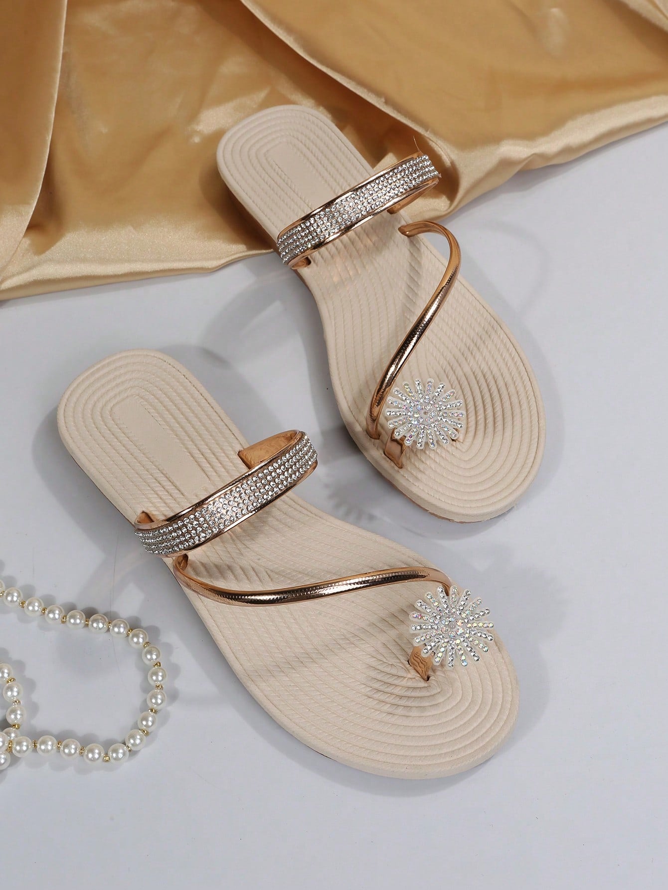 Women's casual flat sandals with slip-on criss-cross straps, toe post design, and rhinestone detail, suitable for beach and summer vacation wear.