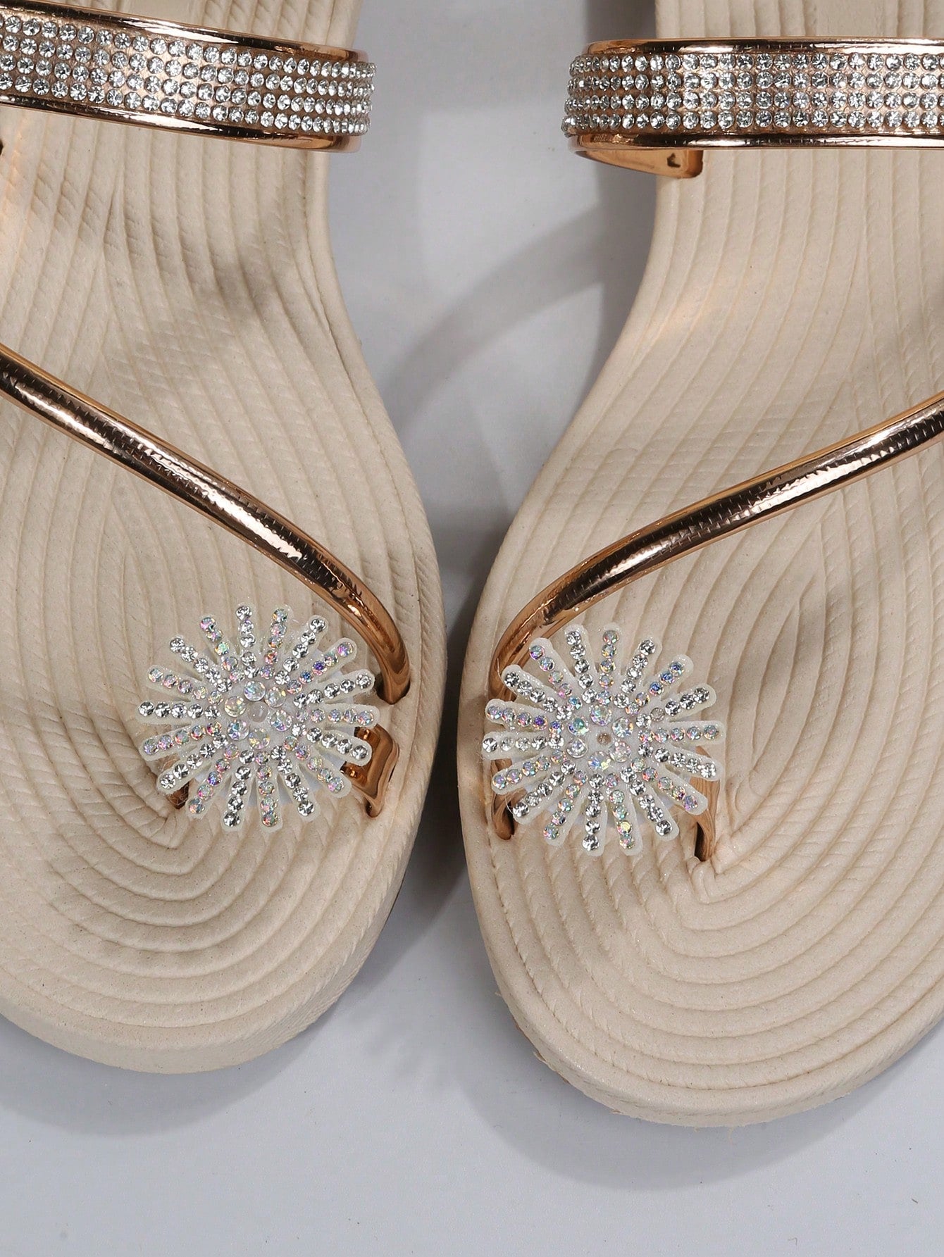 Women's casual flat sandals with slip-on criss-cross straps, toe post design, and rhinestone detail, suitable for beach and summer vacation wear.