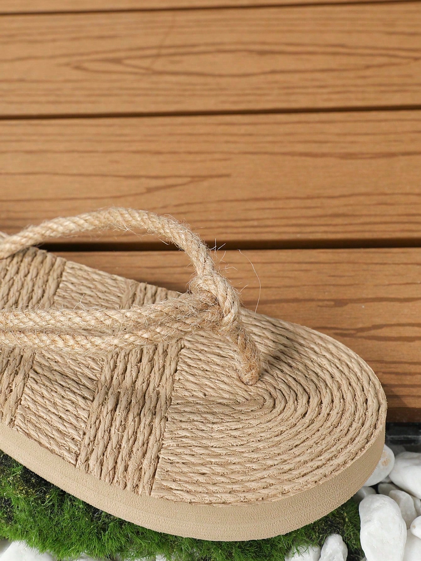 Pair of women's flat woven-look slippers with rope detail, designed for casual outdoor and beachside wear.