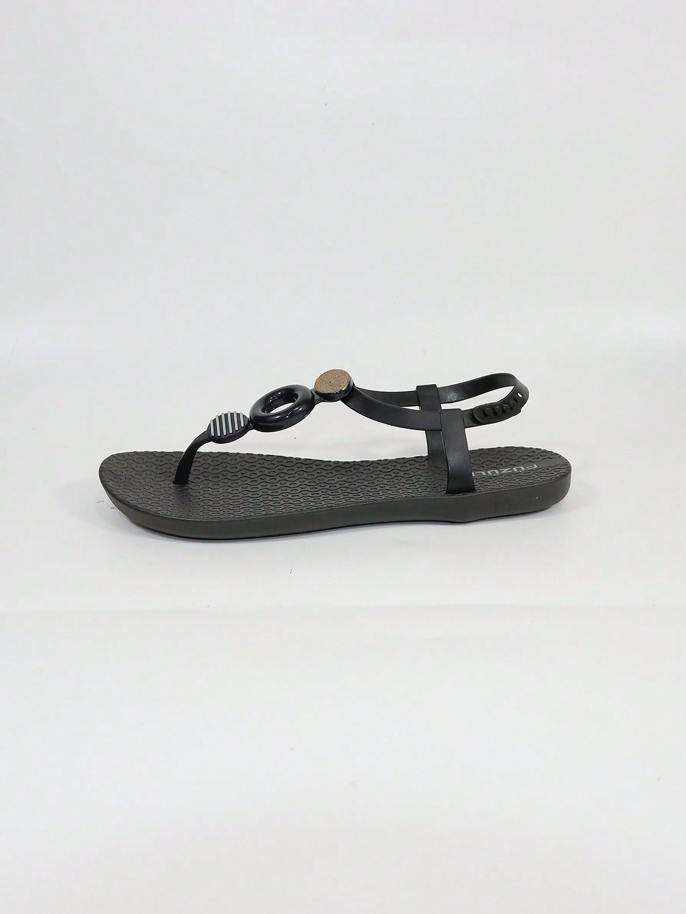 Black women's flat thong sandals with toe post and rhinestone embellishment, slip-on beach flip flop style.