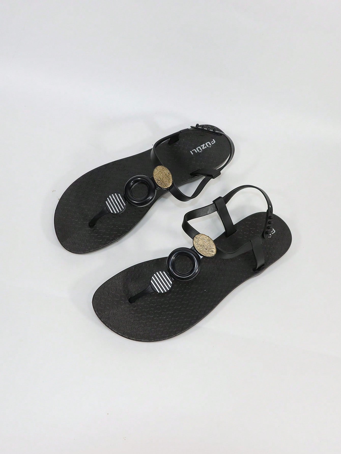 Black women's flat thong sandals with toe post and rhinestone embellishment, slip-on beach flip flop style.