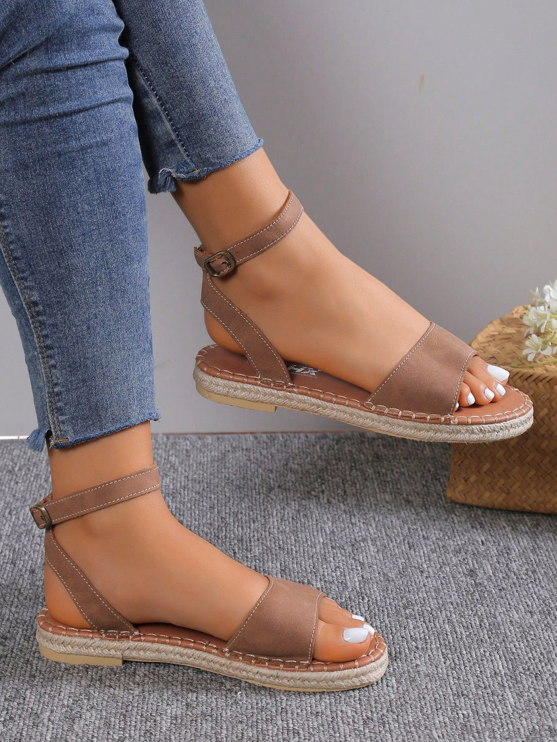 Women's woven Roman slide sandals with buckle detail, flat sole, and open-toe design for casual outdoor wear.