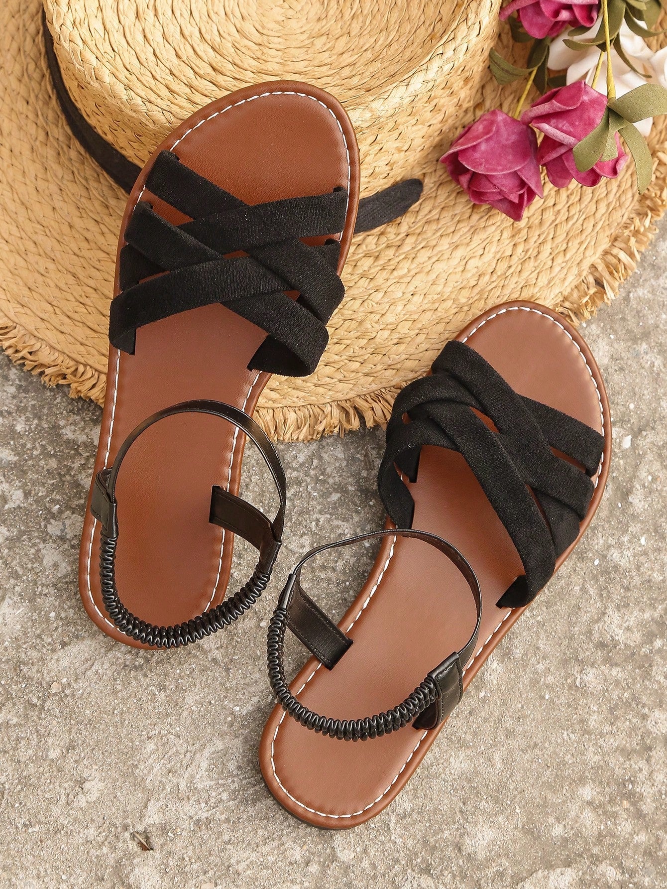 Women's black flat sandals with criss cross straps, ankle strap with buckle, and open toe design