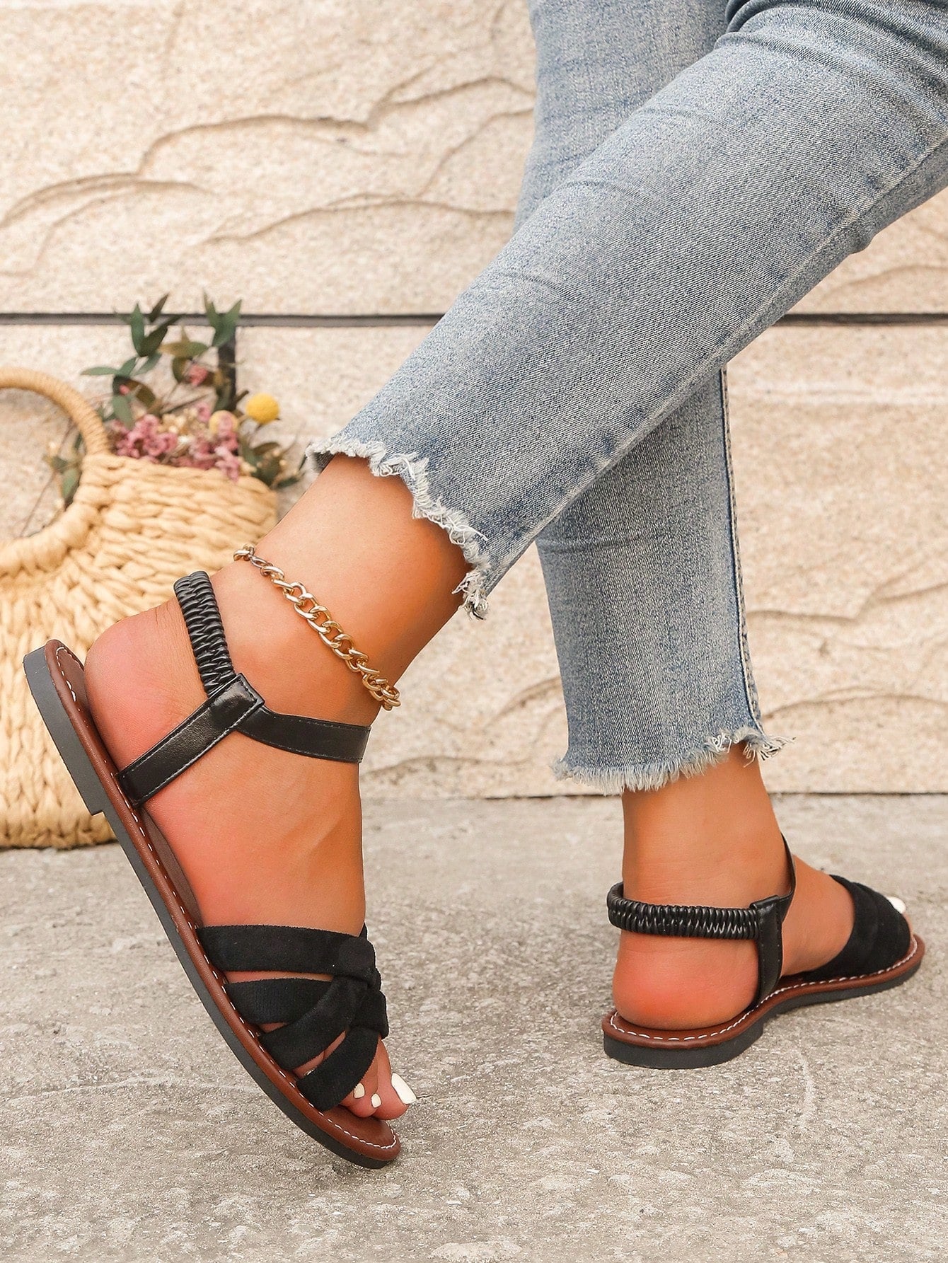 Women's black flat sandals with criss cross straps, ankle strap with buckle, and open toe design
