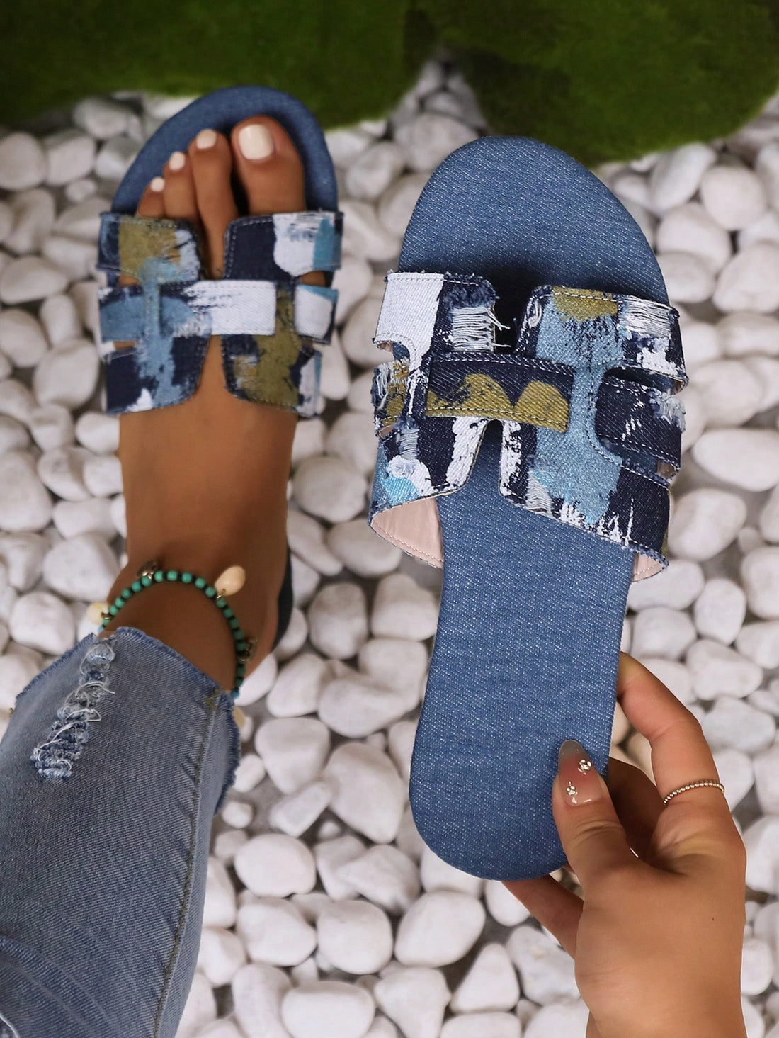 Blue women’s flat slide sandals with graphic print, buckle decor, and open-toe design.