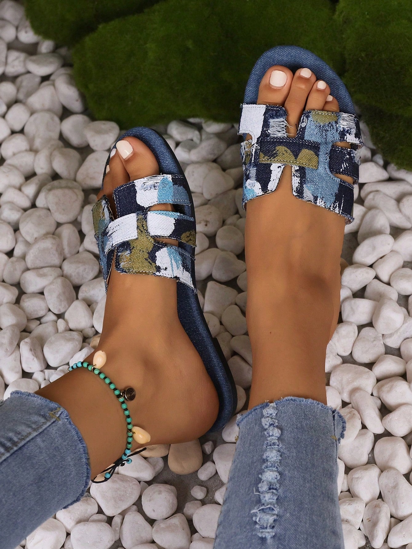 Blue women’s flat slide sandals with graphic print, buckle decor, and open-toe design.