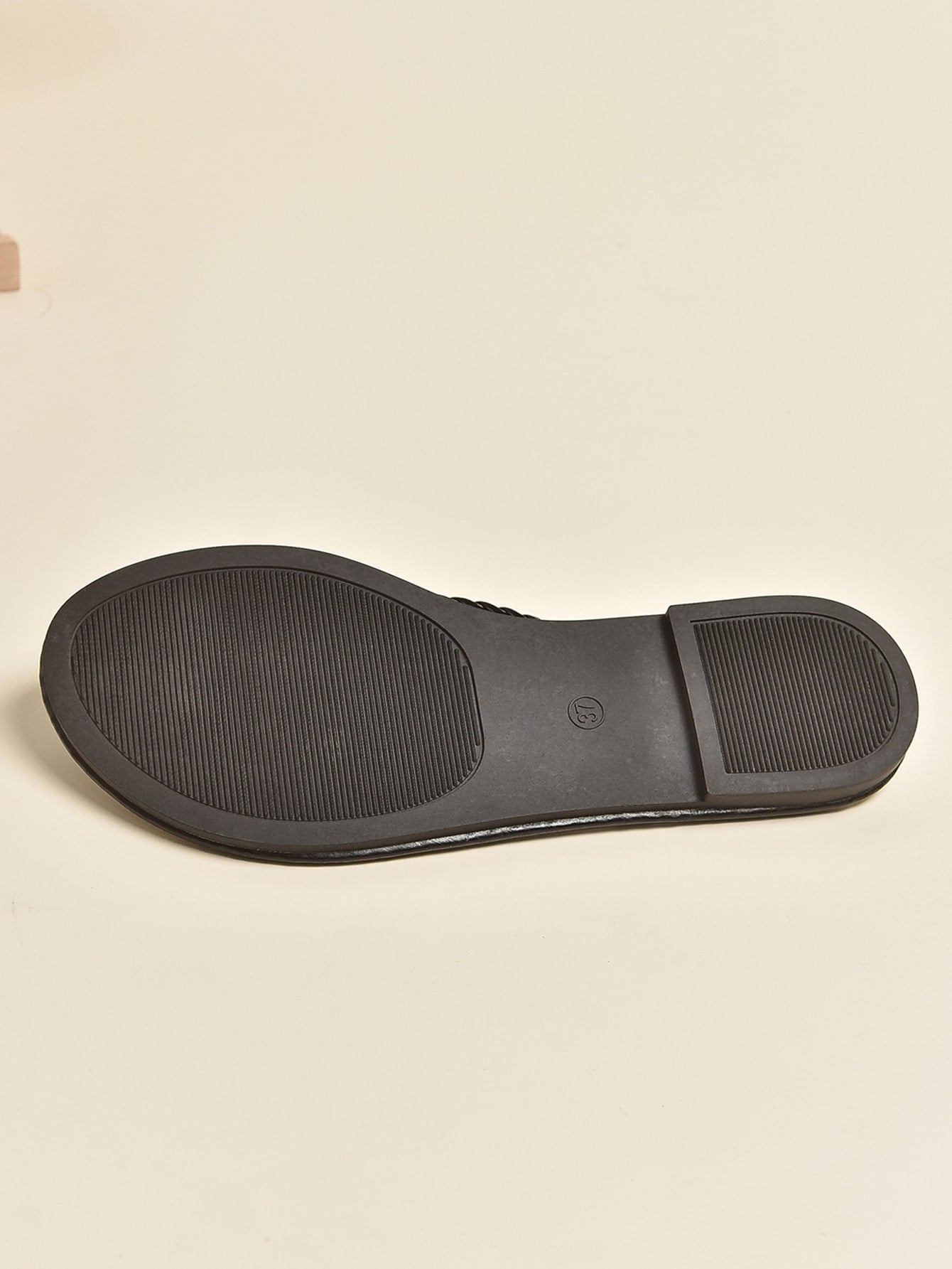 Women's braided detail flat thong sandals with toe post, casual outdoor style.