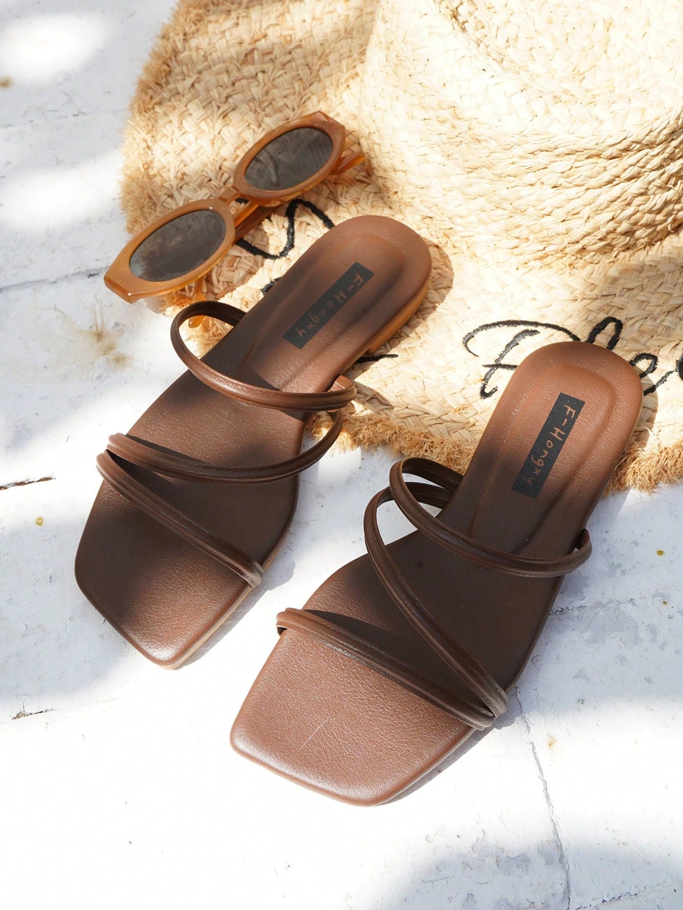 Women's slip-on flat slide sandals with bow tie decor, textured plain upper, and open toe.