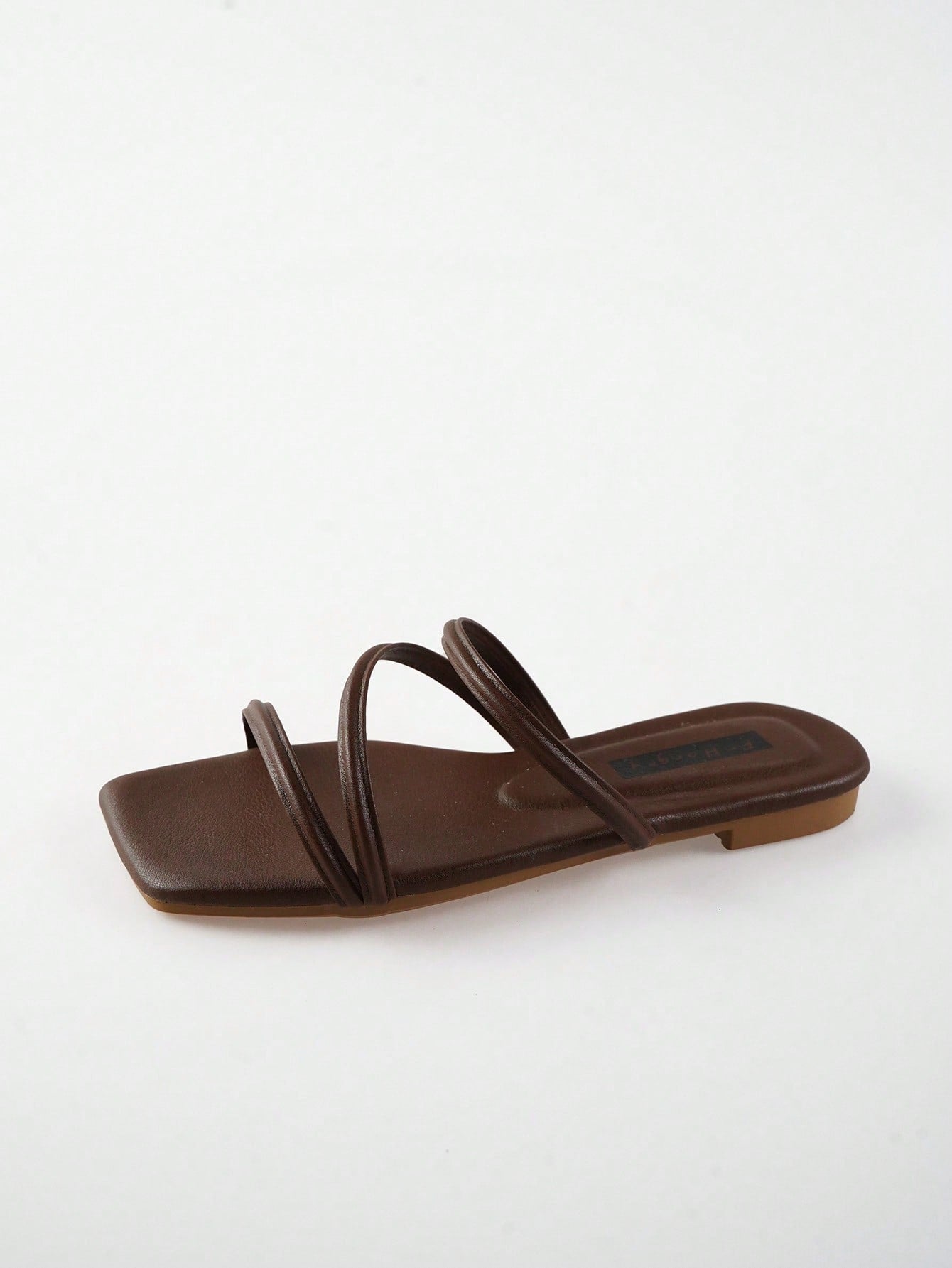 Women's slip-on flat slide sandals with bow tie decor, textured plain upper, and open toe.