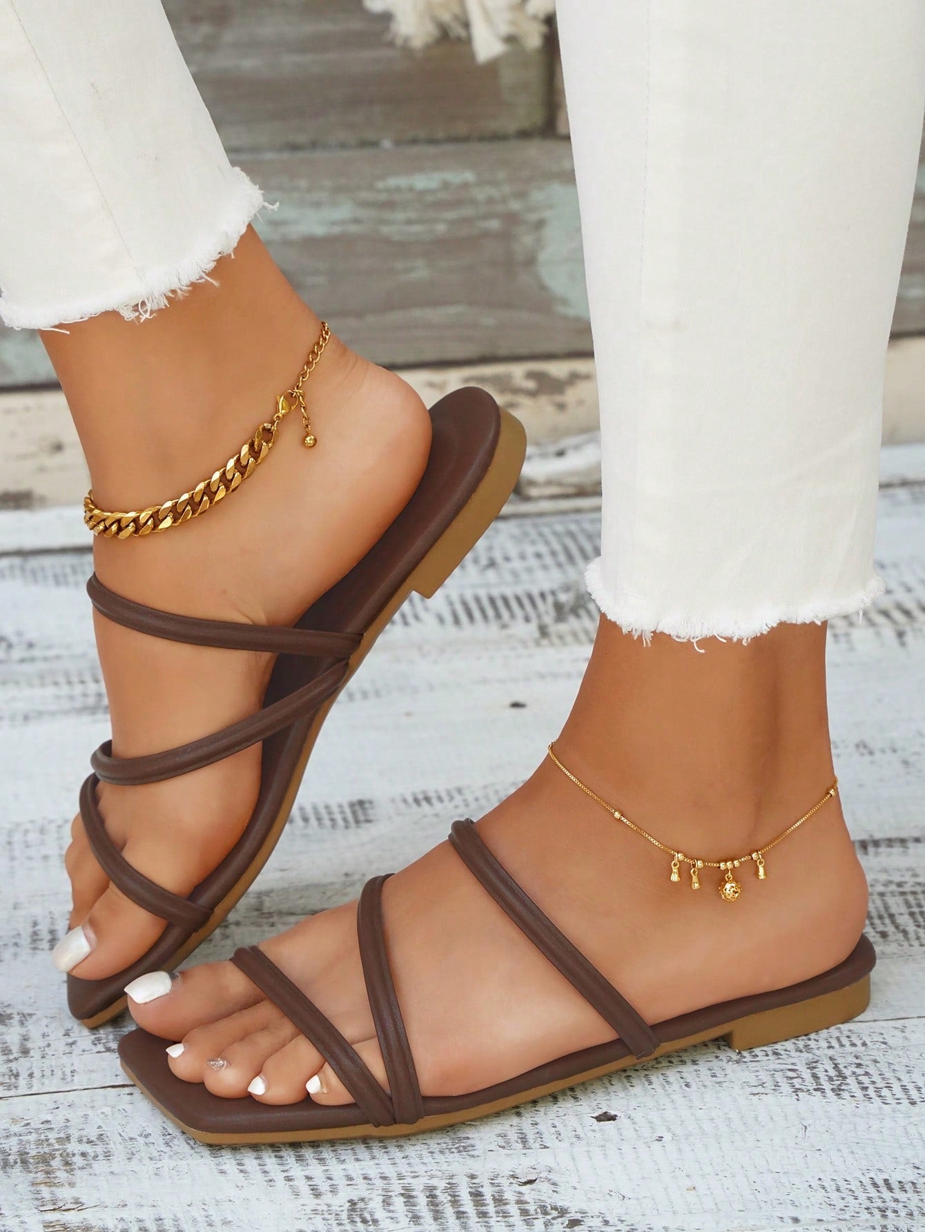 Women's slip-on flat slide sandals with bow tie decor, textured plain upper, and open toe.