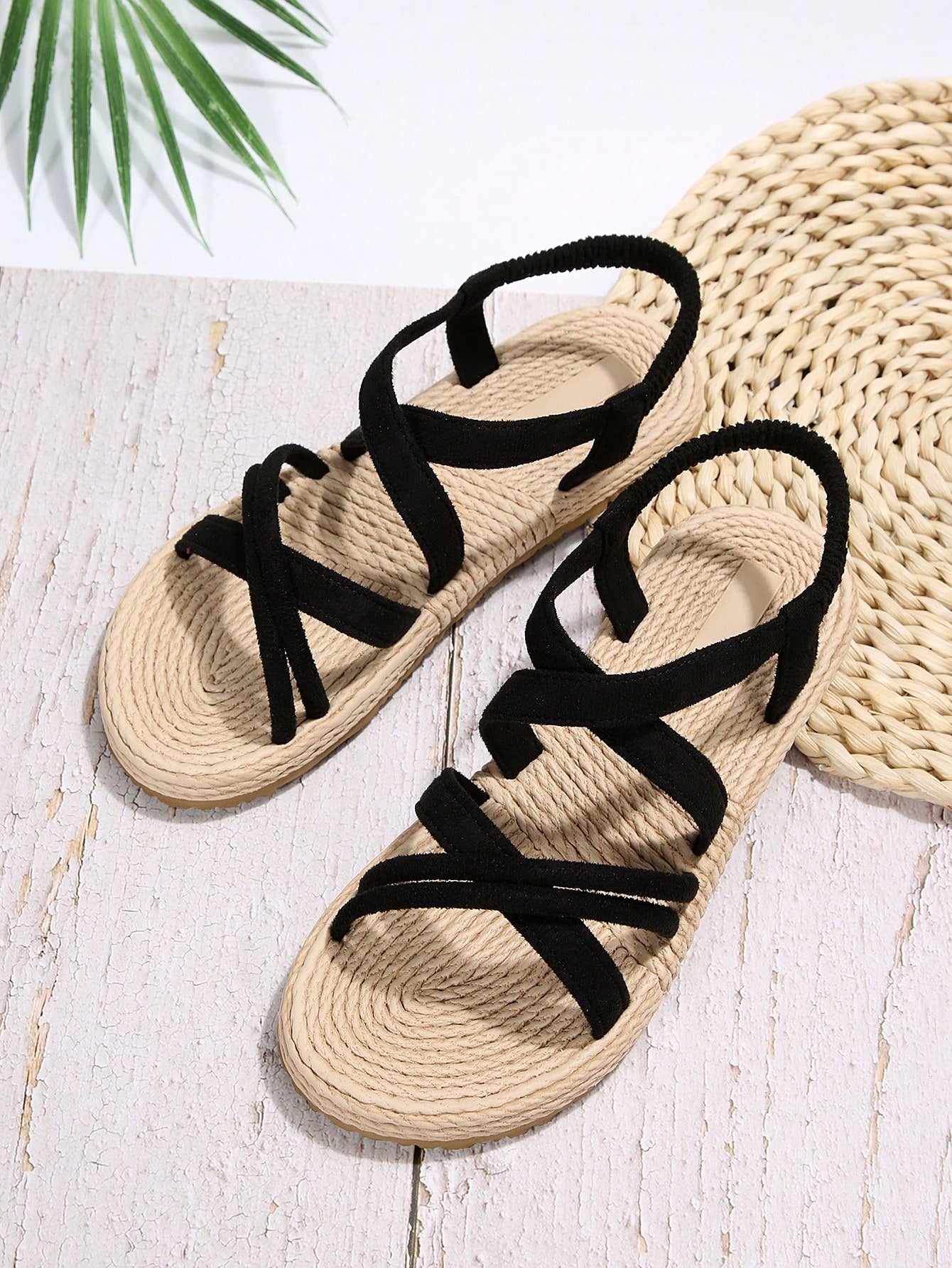 Women’s flat open-toe slide sandals with criss-cross woven straps and a plain casual design for daily, beach, and summer outdoor wear.