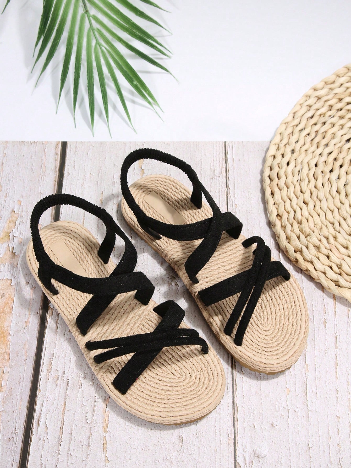 Women’s flat open-toe slide sandals with criss-cross woven straps and a plain casual design for daily, beach, and summer outdoor wear.