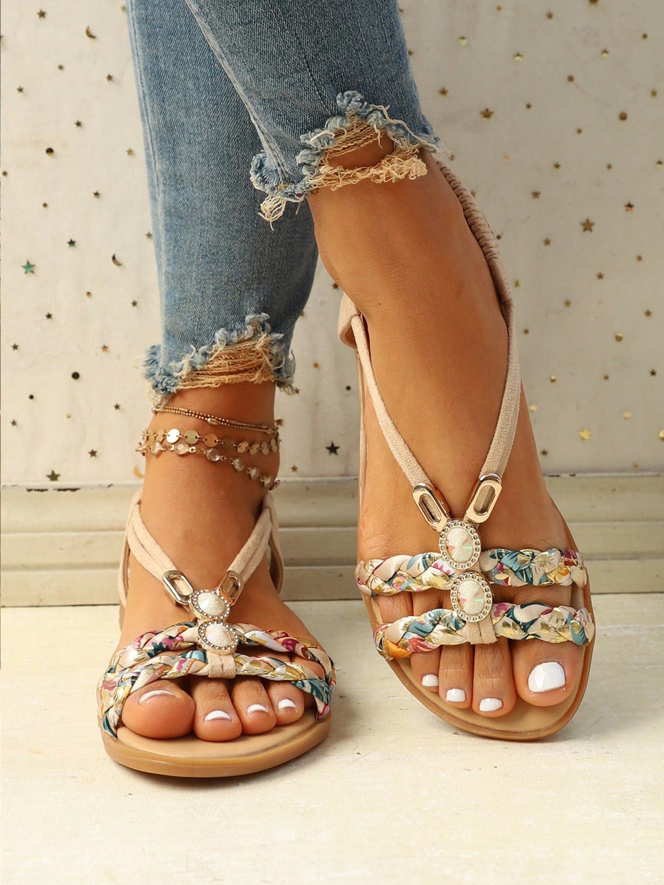 Women’s flat slingback sandals with floral pattern styling, braid detail, rhinestone accents, and open toe design
