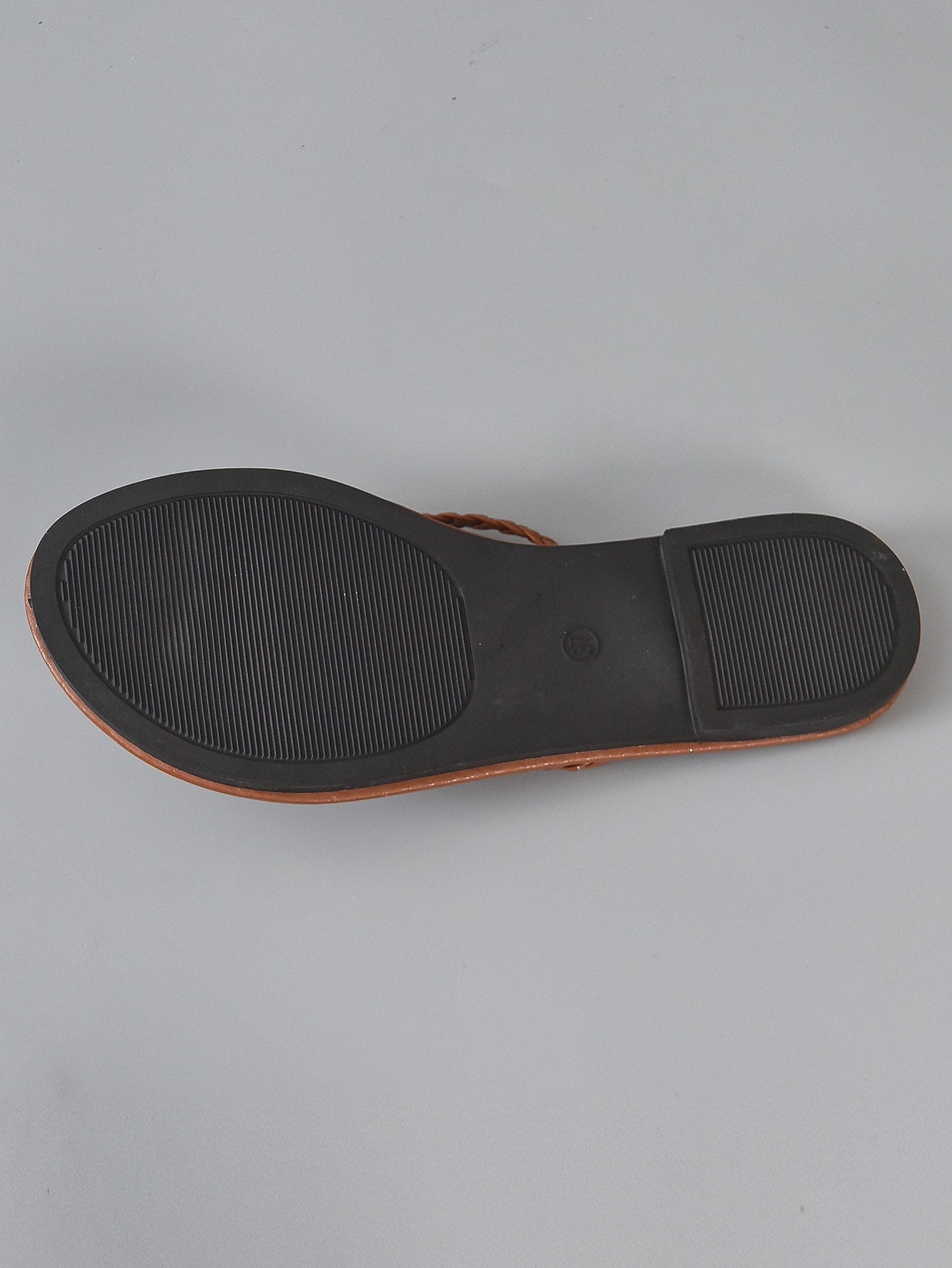 Women's braided detail flat thong sandals with toe post, casual outdoor style.