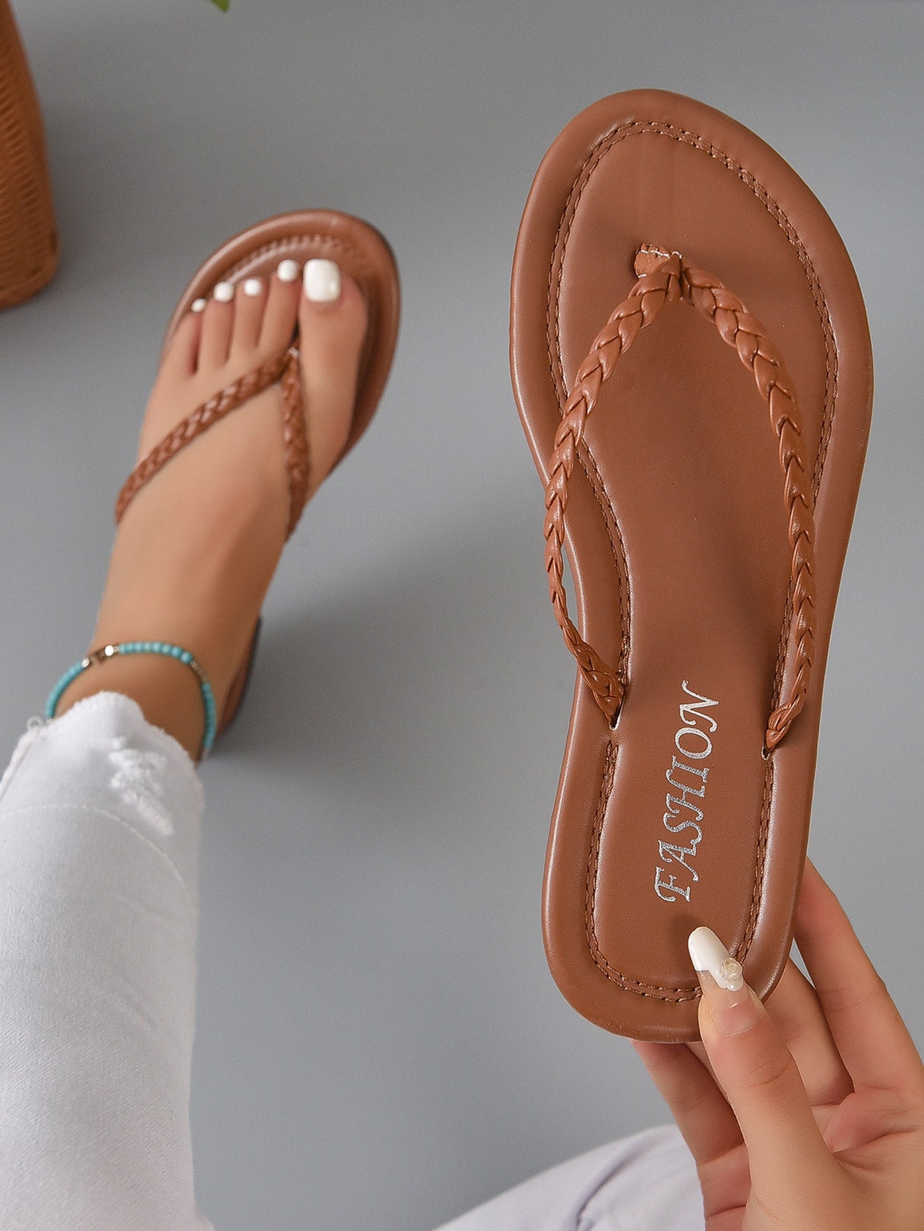 Women's braided detail flat thong sandals with toe post, casual outdoor style.