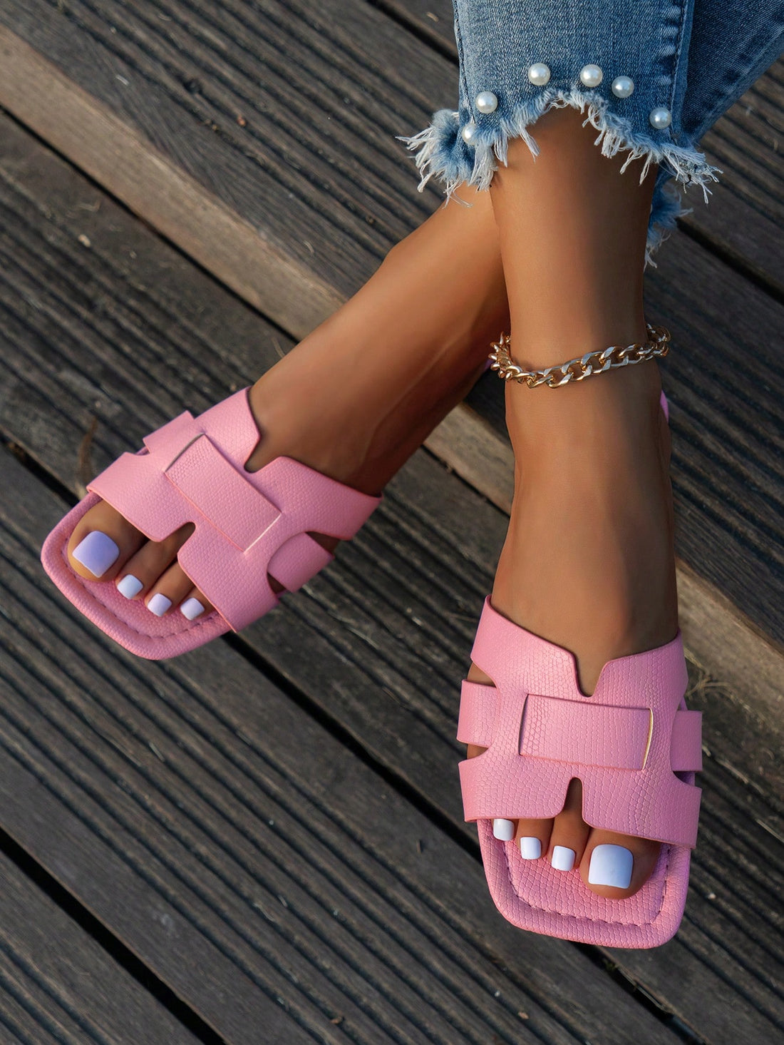Women's Korean-style casual flat slide sandals with open toe, geometric detail, and pink color.