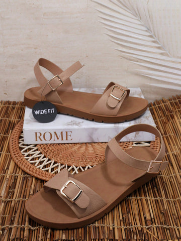 Women’s wide fit flat sandals with an open toe, plain design, and buckle detail, suitable for casual beach and vacation wear.