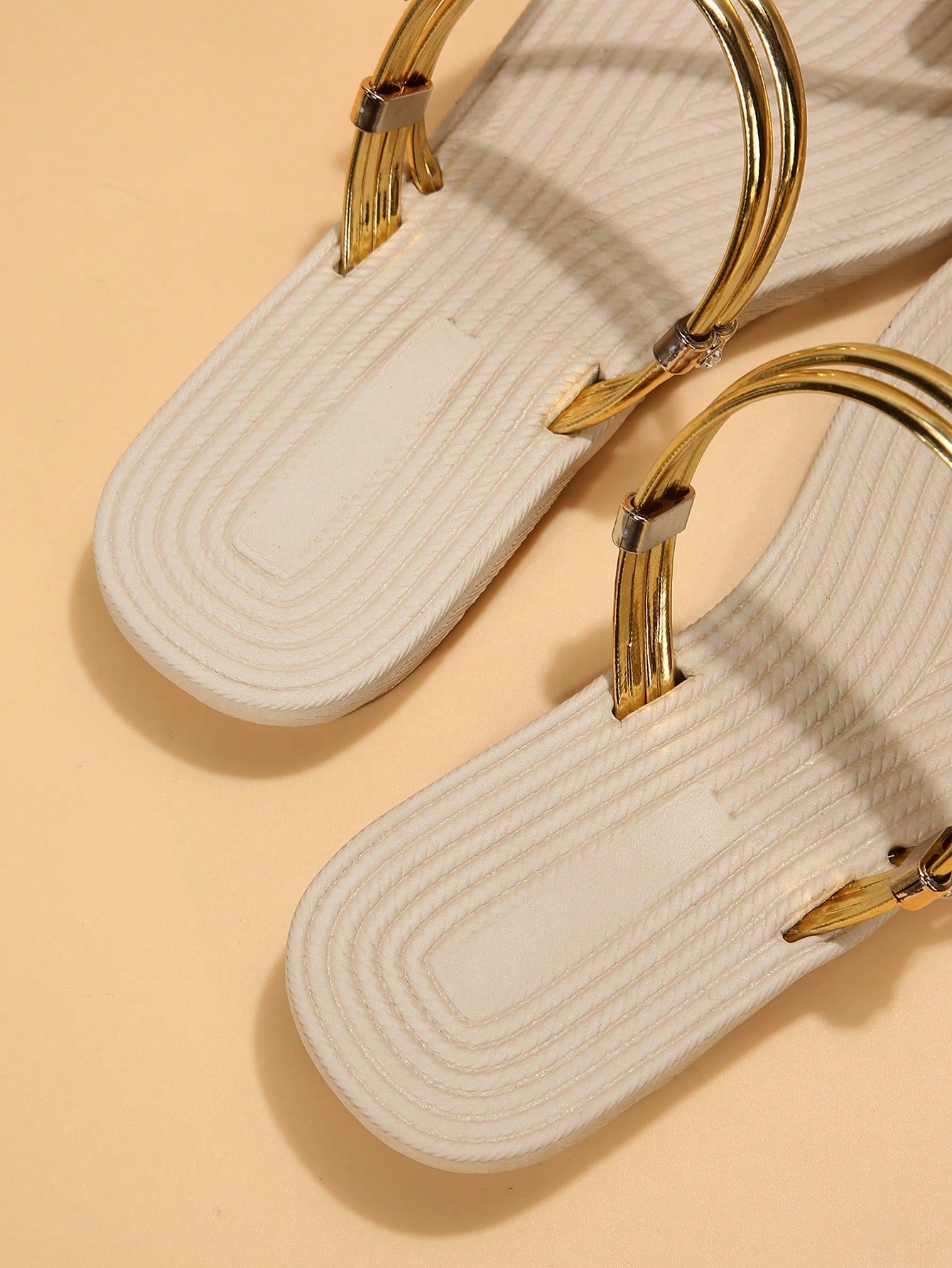 Women's open-toe strappy flat sandals with tasseled upper, seashell-inspired decoration, and rhinestone detail, designed for lightweight, comfortable beach and casual indoor or outdoor wear.