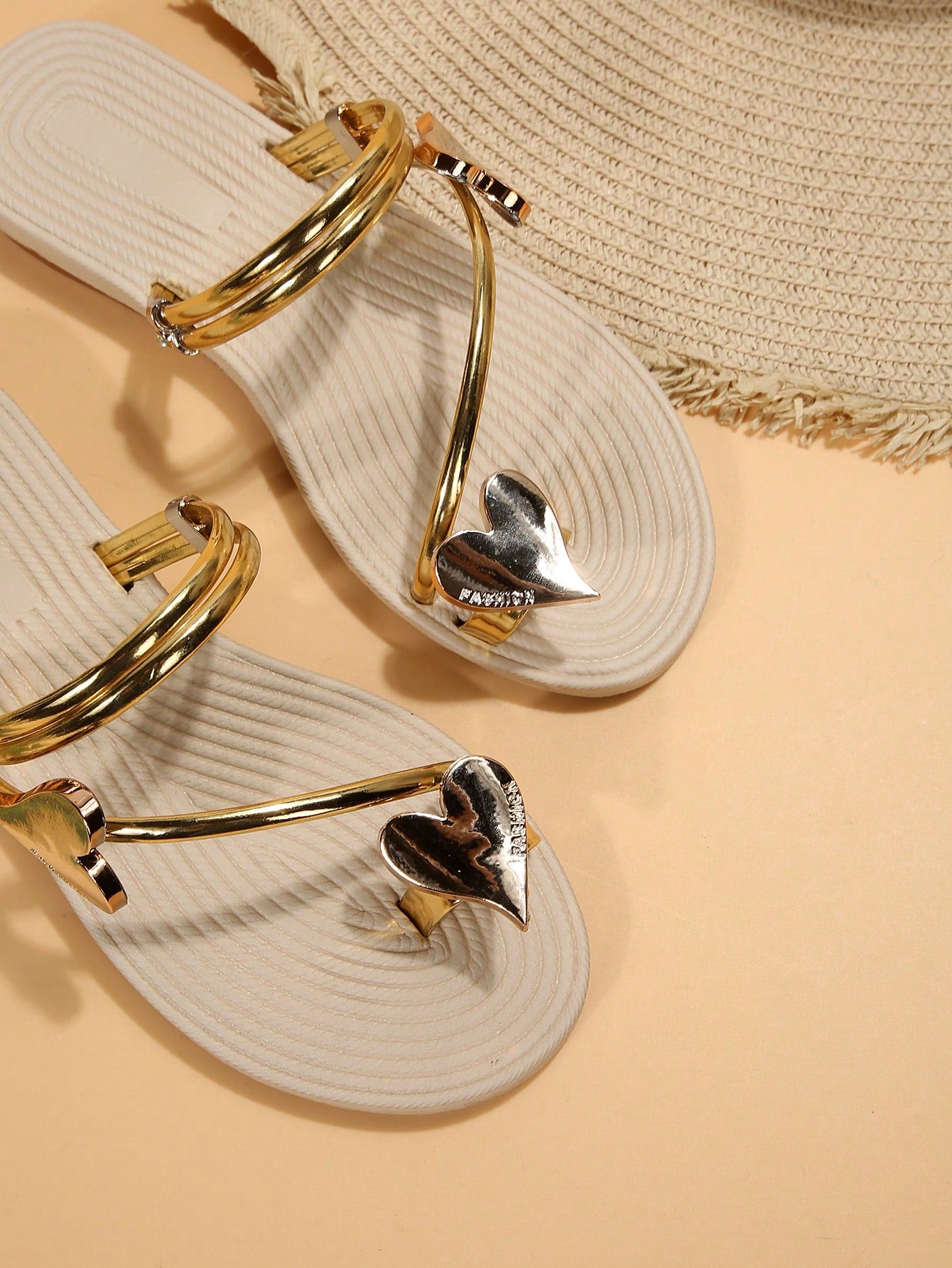 Women's open-toe strappy flat sandals with tasseled upper, seashell-inspired decoration, and rhinestone detail, designed for lightweight, comfortable beach and casual indoor or outdoor wear.