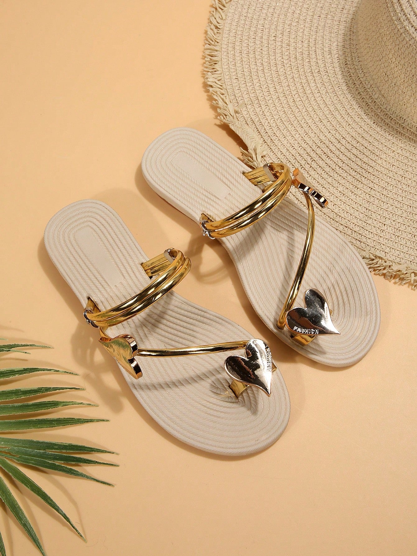 Women's open-toe strappy flat sandals with tasseled upper, seashell-inspired decoration, and rhinestone detail, designed for lightweight, comfortable beach and casual indoor or outdoor wear.