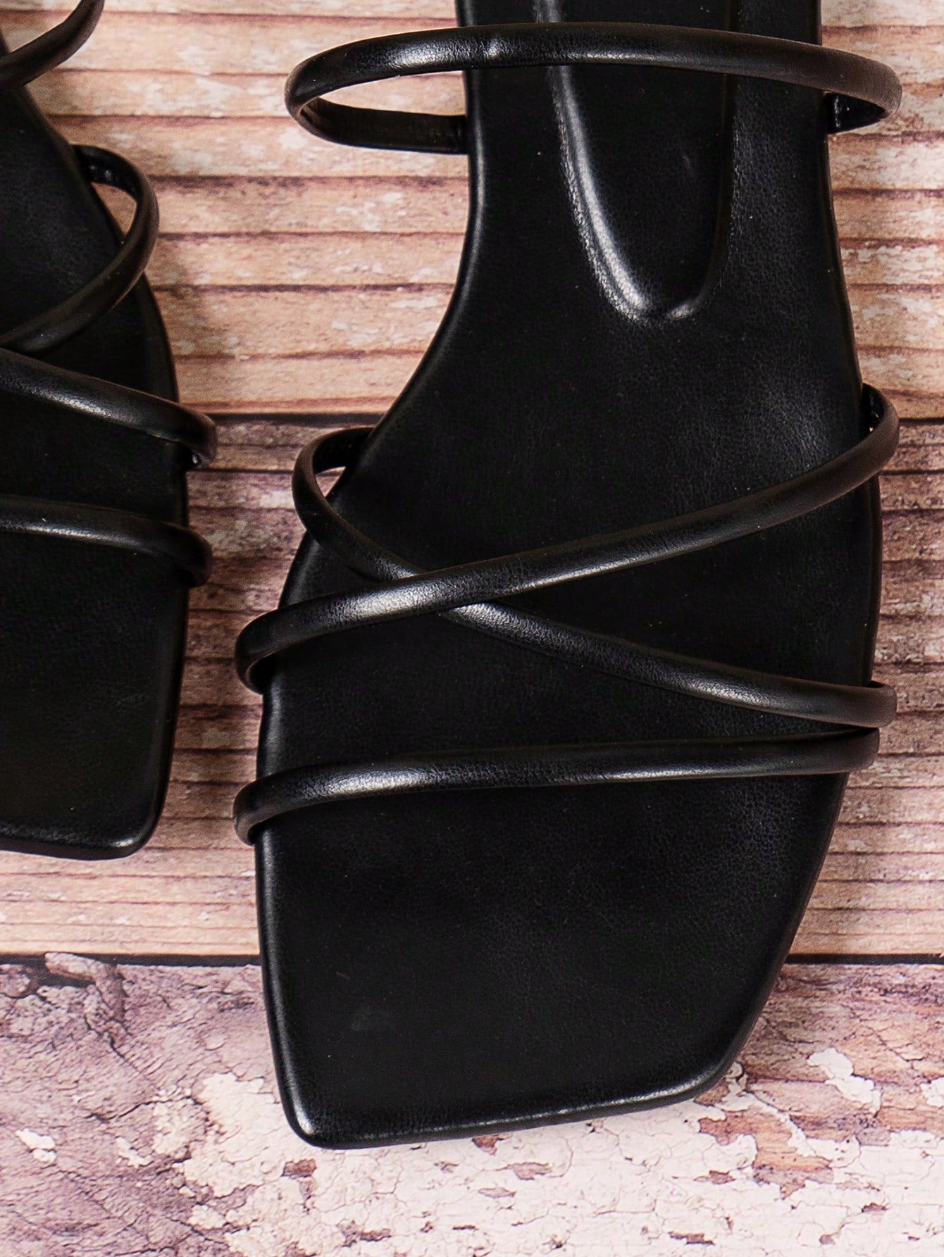Solid color PU leather flat sandals with criss-cross straps, open toe, and ankle strap design for beach and holiday summer wear.