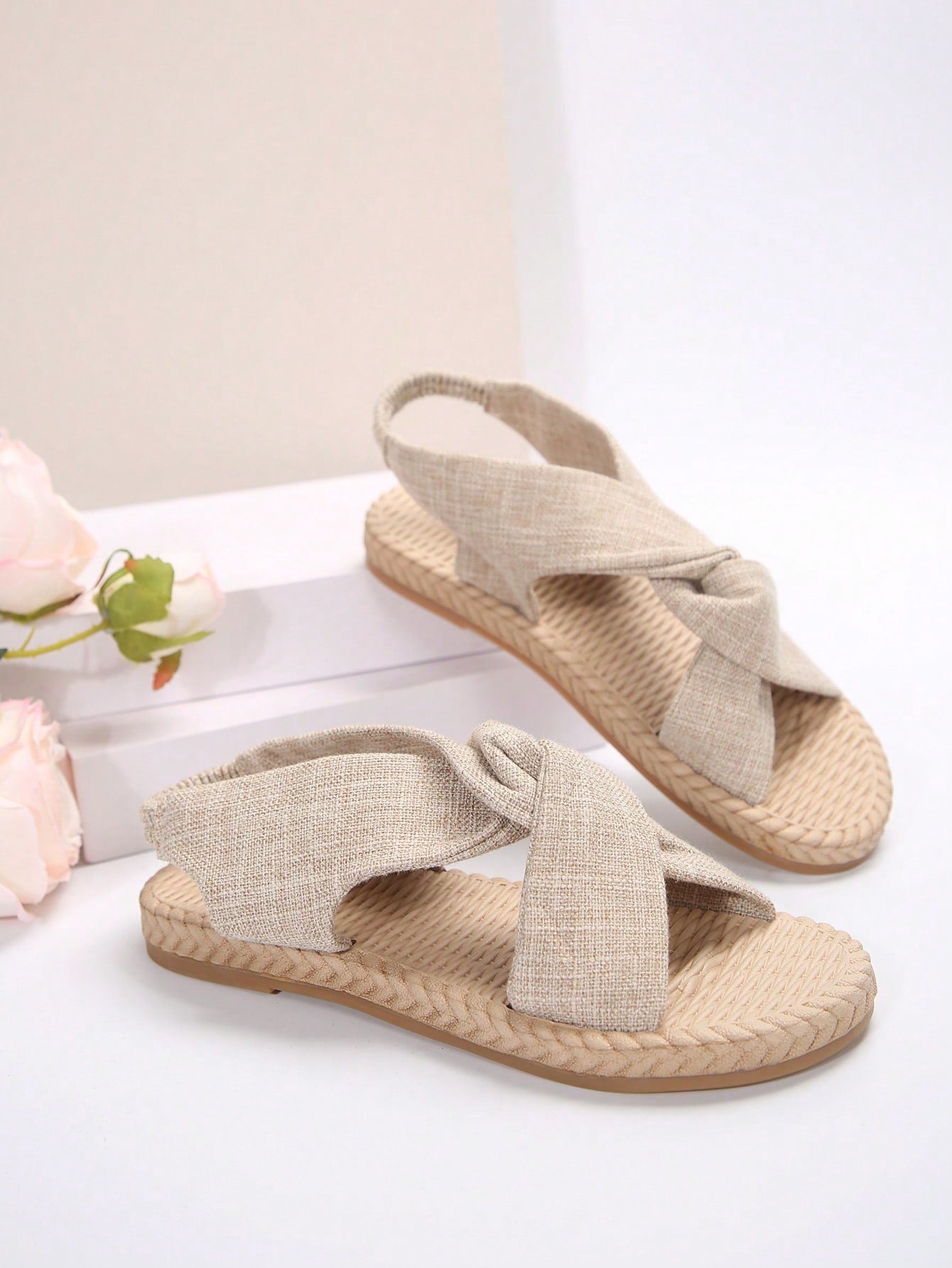 Women's flat gladiator sandals with twist strap detail, crossed-back straps, and open toe design for beach and outdoor wear.