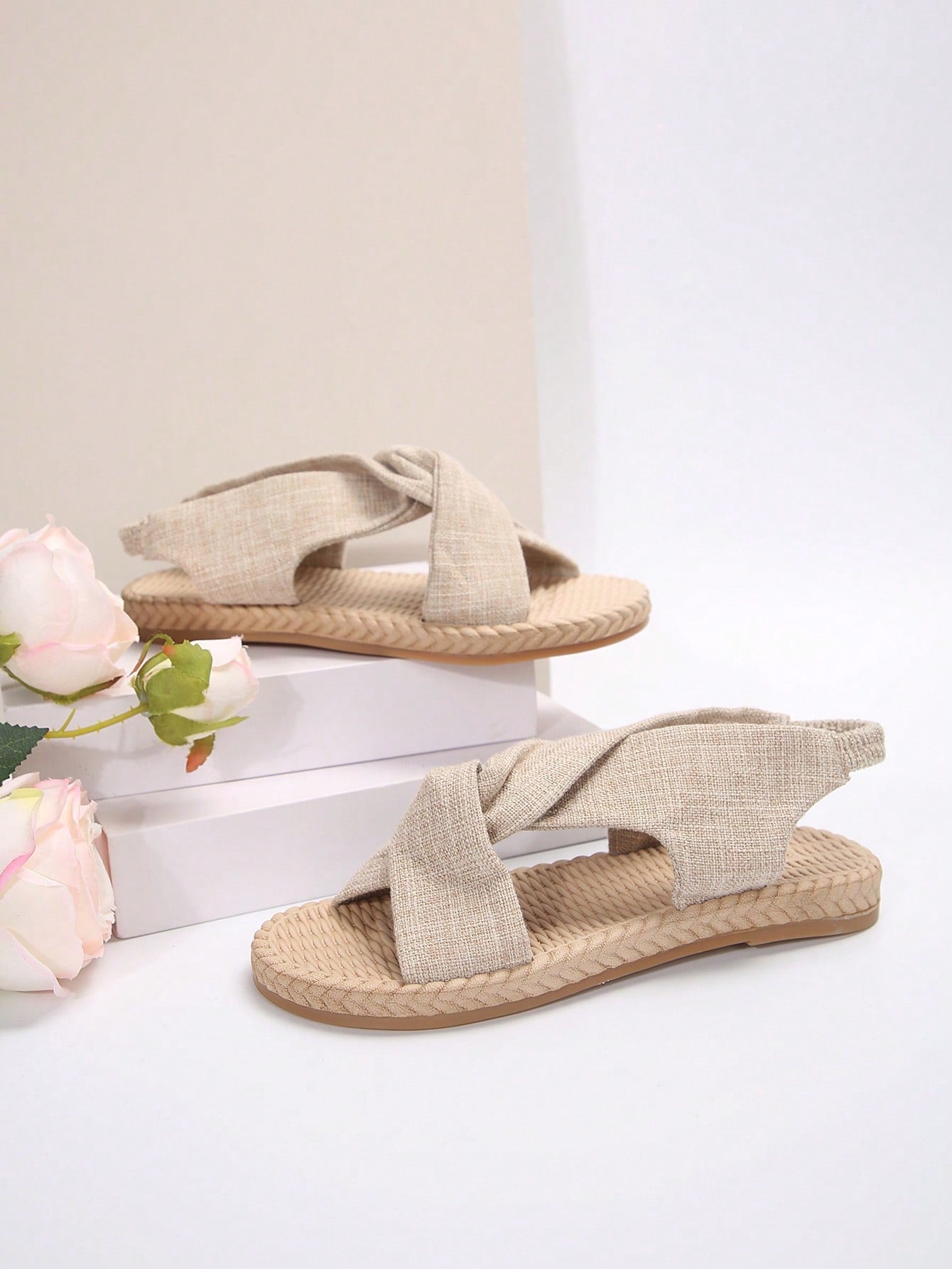 Women's flat gladiator sandals with twist strap detail, crossed-back straps, and open toe design for beach and outdoor wear.