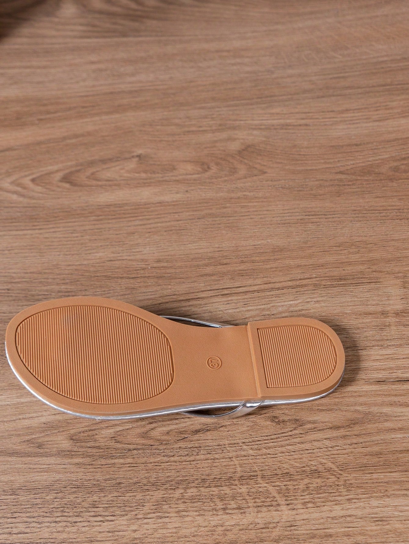 Women's criss cross thong flip flops with lace-up detail, flat sole, and non-slip outsole, suitable for beach, holiday, and casual walking wear.