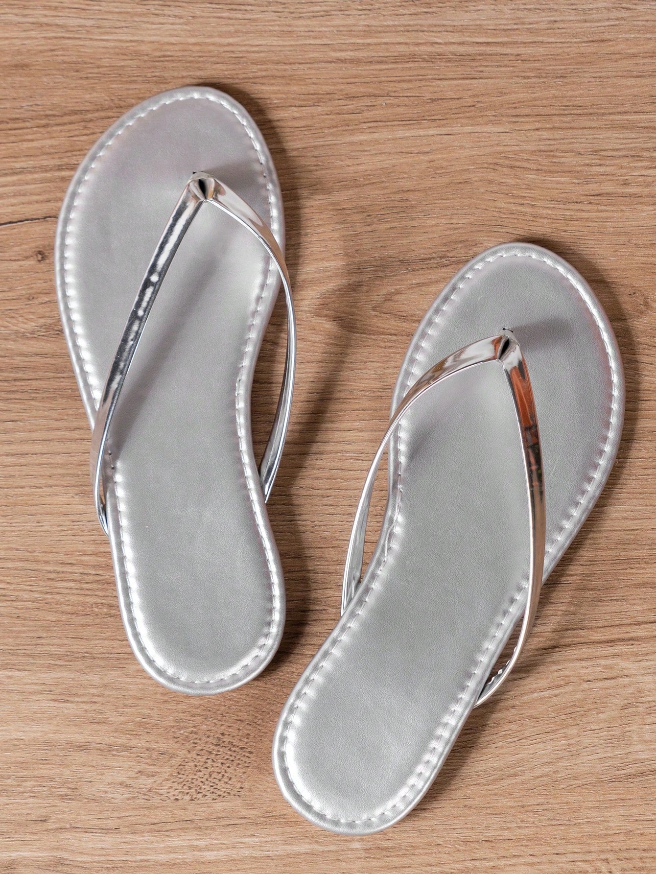 Women's criss cross thong flip flops with lace-up detail, flat sole, and non-slip outsole, suitable for beach, holiday, and casual walking wear.