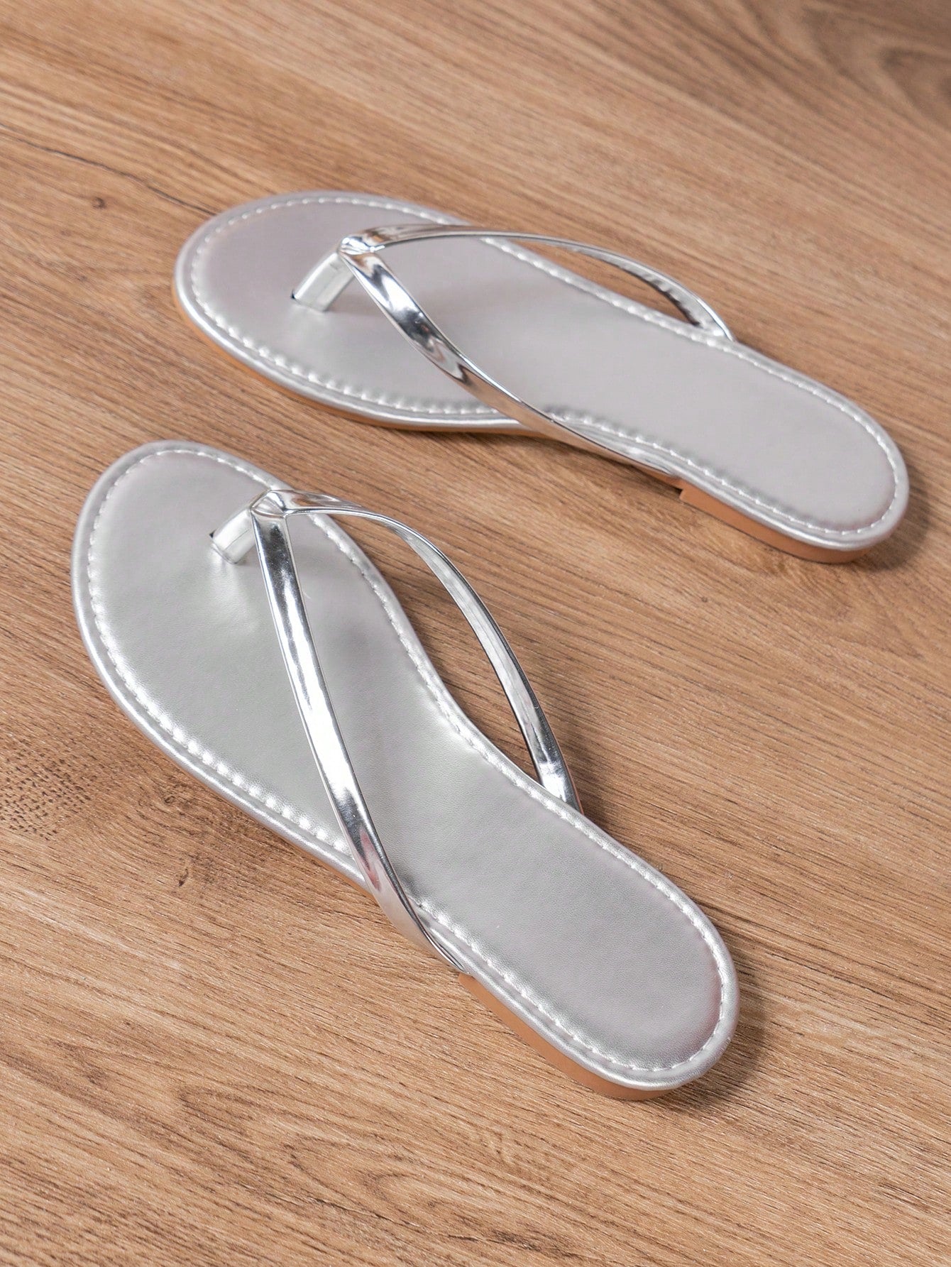 Women's criss cross thong flip flops with lace-up detail, flat sole, and non-slip outsole, suitable for beach, holiday, and casual walking wear.