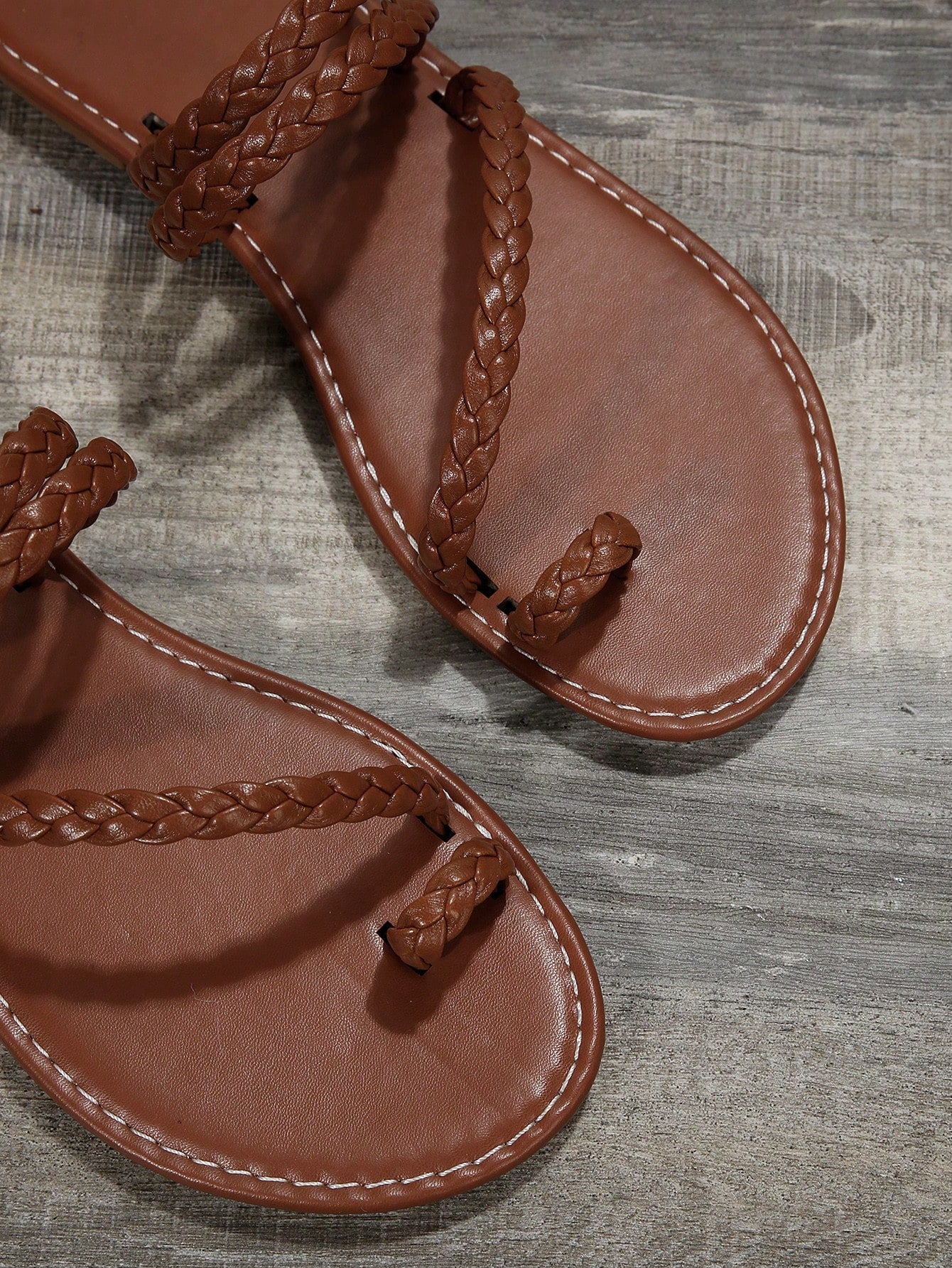 Women's flat slip-on sandal with toe ring and cross-over strappy upper, designed for casual beach and outdoor wear with an anti-slip sole.