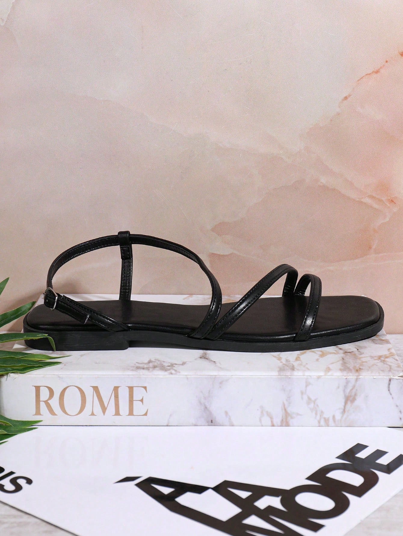Women's flat open-toe sandals featuring a buckle detail and PU leather construction with a flat sole.