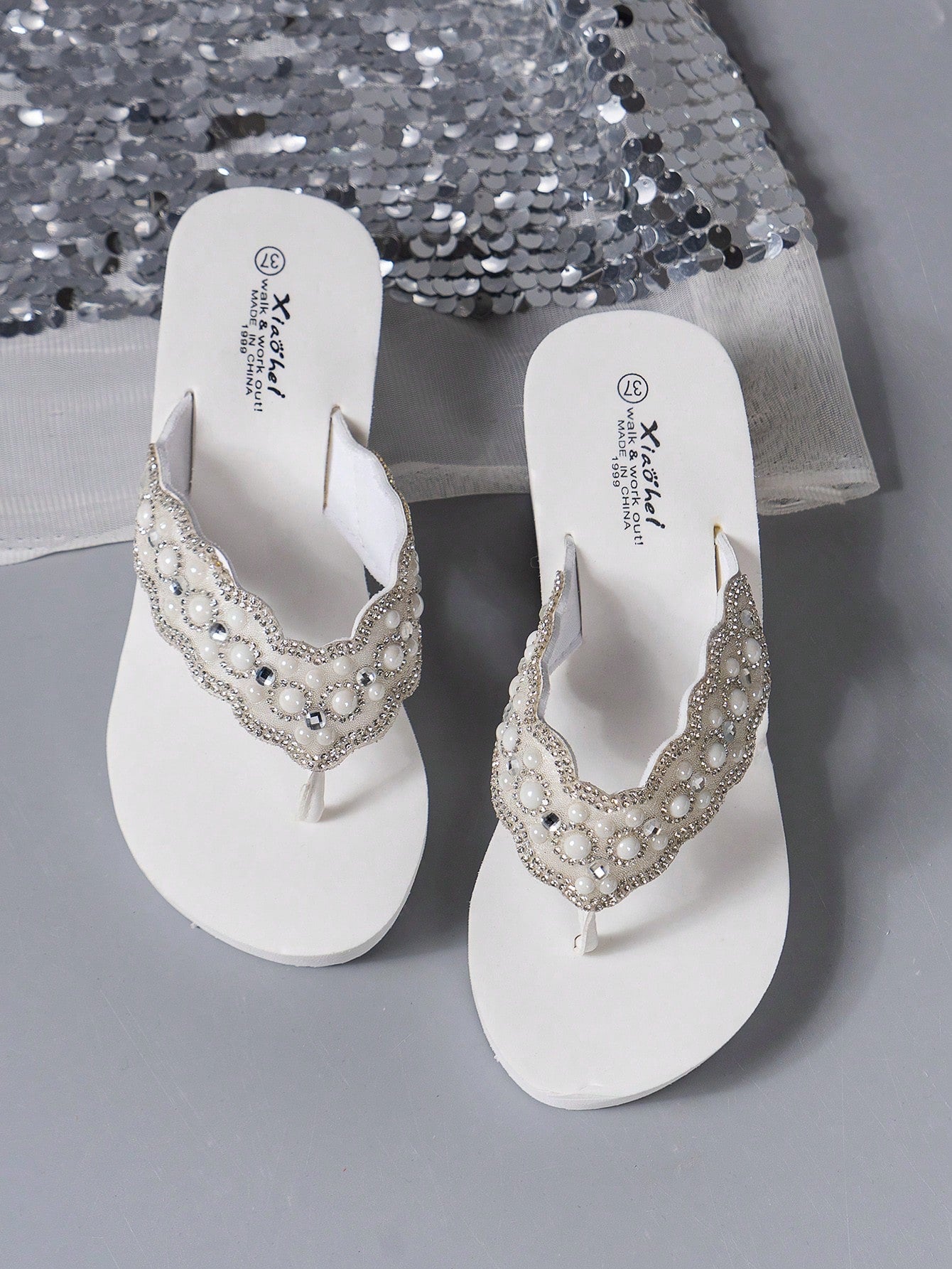 Women's pearl decor thong sandals with rhinestone embellishments, strappy slip-on design, and wedge heel, suitable for beach and wedding wear.