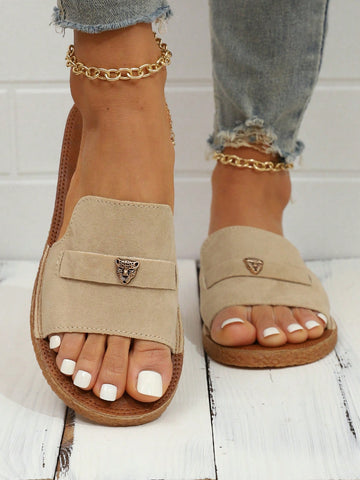 Women's flat slide sandals featuring a fabric strap with bow pendant, visible stitching detail, and open-toe design in a casual beach and vacation style.