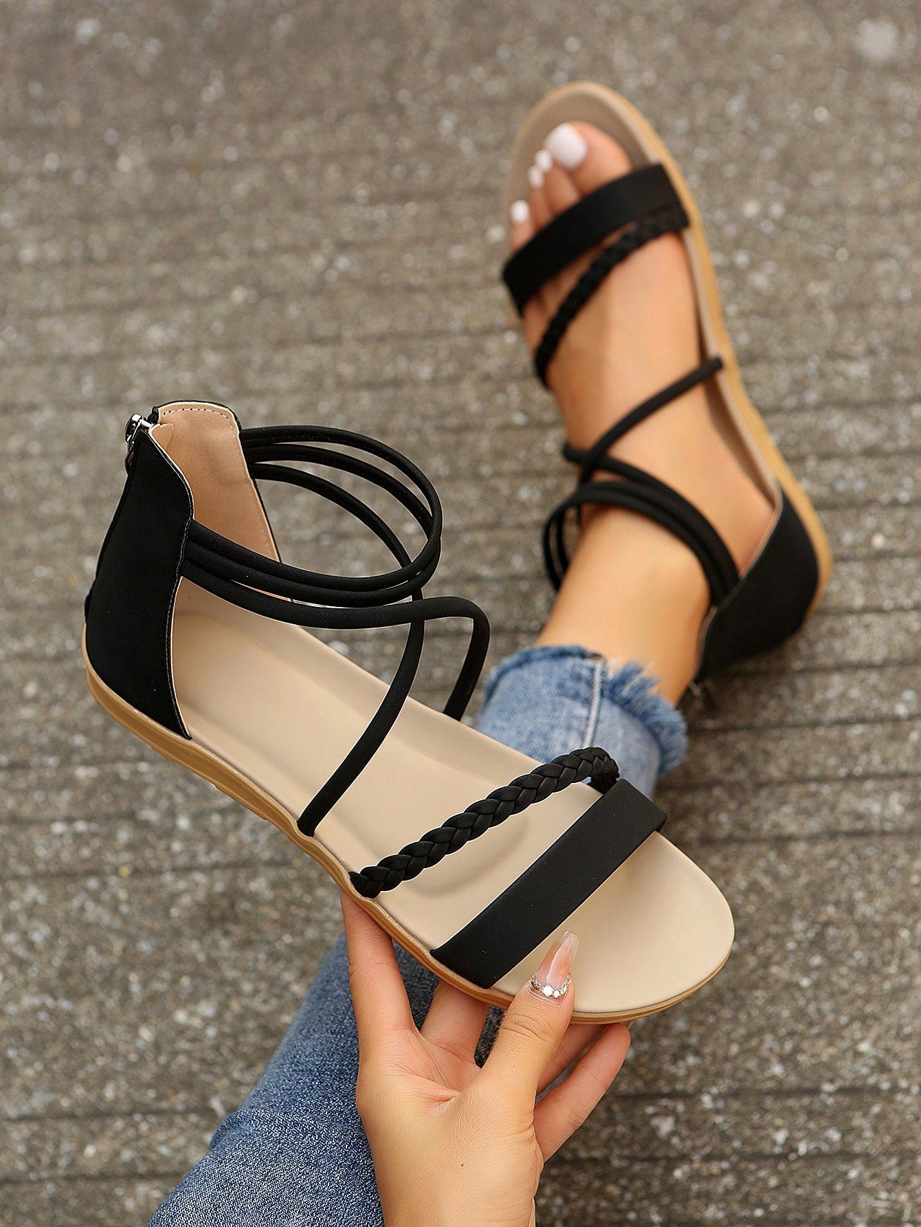 Women’s flat gladiator sandals with braided detail and an open-toe design, suitable for beach and outdoor wear.