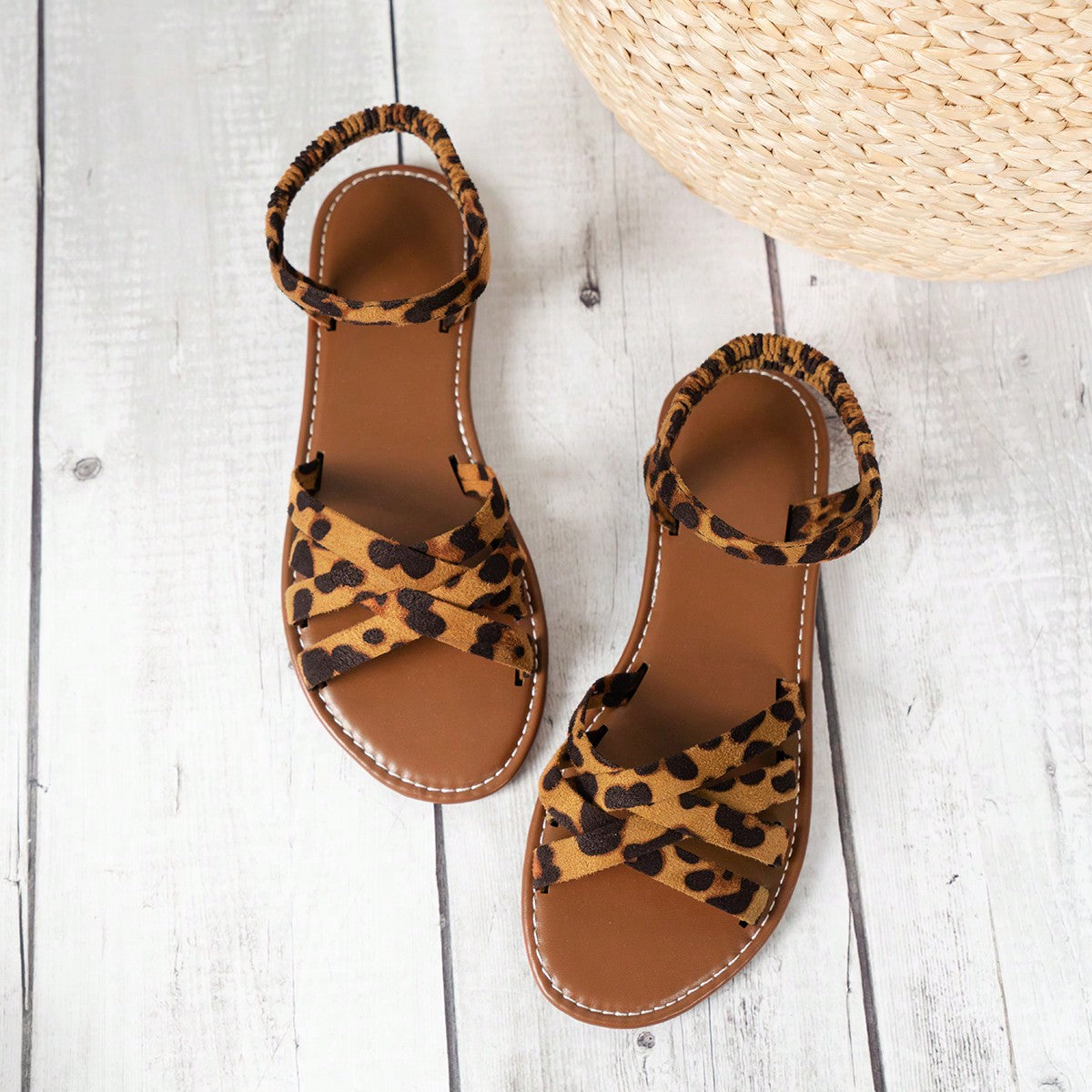 Women’s blue flat gladiator sandals with buckle and criss cross straps, round toe, and plaid pattern, styled as casual woven beach slippers.