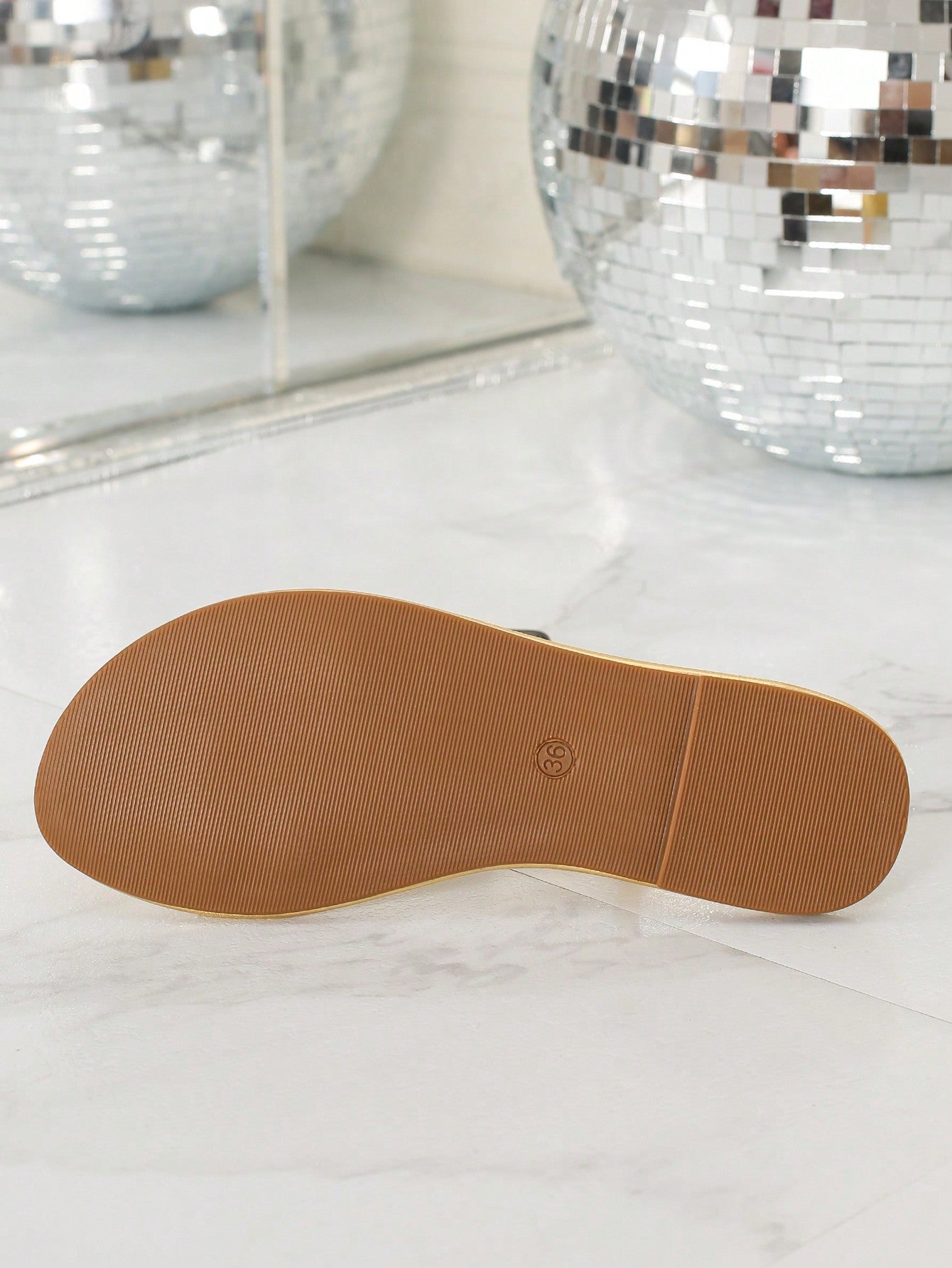 Women's slip-on flat sandals featuring round toe styling, a toe post, metal strap detail, and buckle accent, designed for casual beach and warm-weather outfits.