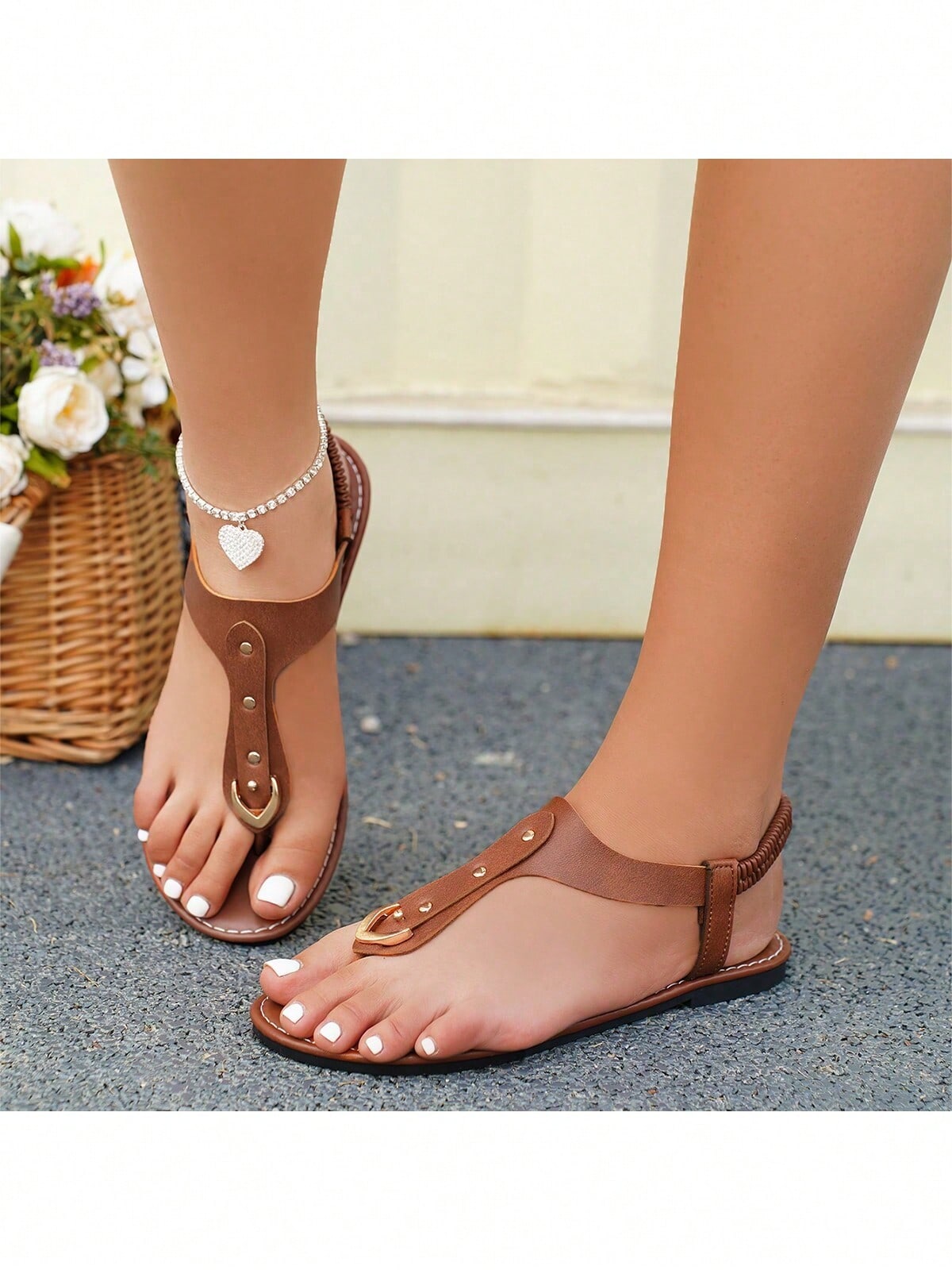 Women's flat slide sandals with rivet decor, elastic strap, buckle detail, and toe post open design for outdoor and beach wear.